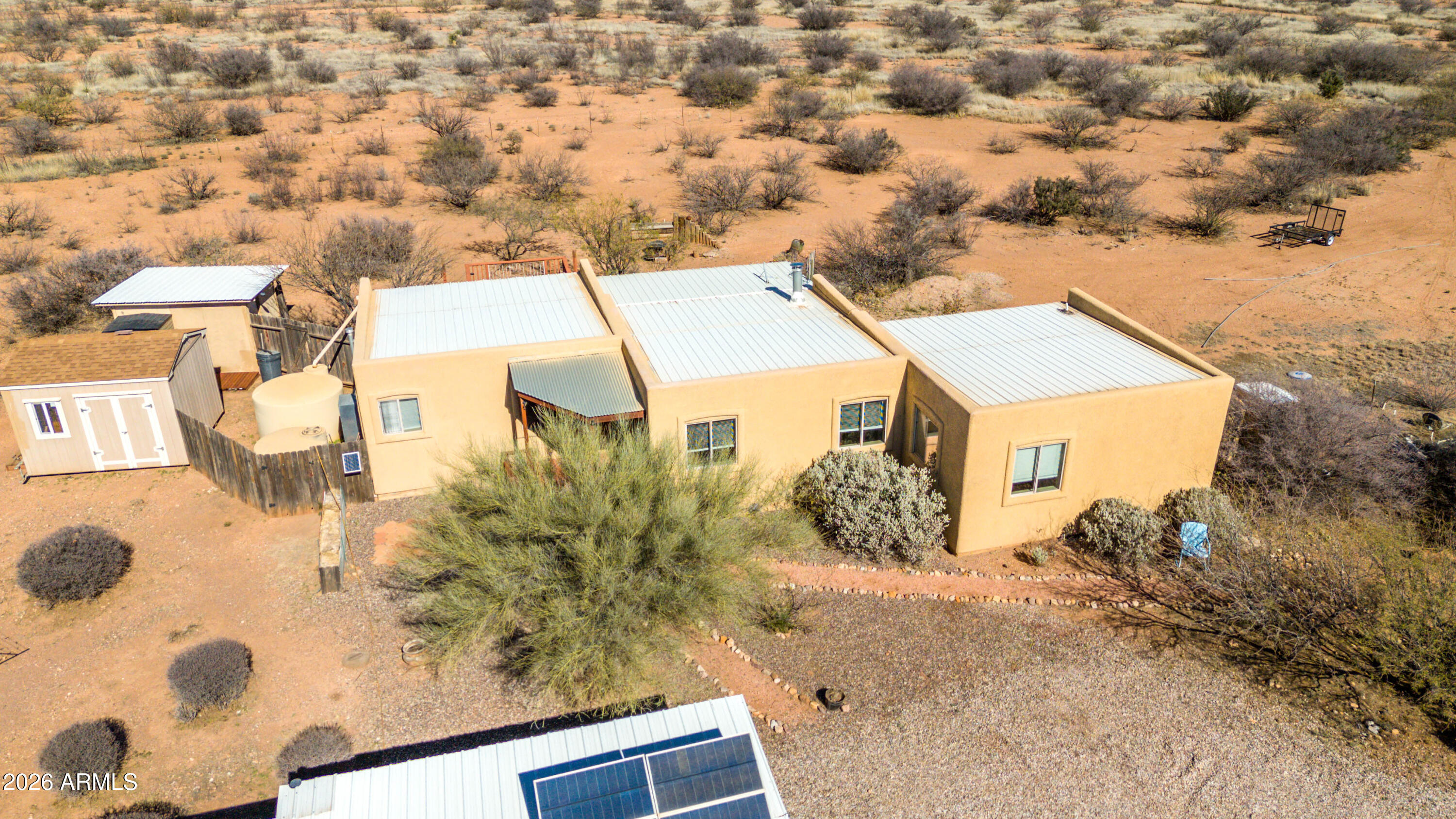 Charming Off-Grid Retreat in a Private, Peaceful Setting! Discover this well-designed off-the-grid home tucked away in a serene and private location, just a short drive from Hwy 92 via a well-maintained dirt road. Built with energy efficiency in mind, the home features 2x6 construction, Low-E windows, and 38 passive solar panels providing reliable electricity. Inside, you'll appreciate custom cabinetry and beautiful hardwood flooring that add warmth and character throughout. Water sustainability is exceptional, with three larger rainwater collection tanks, plus a private registered well with a 500-gallon storage tank powered by a solar pump. An owned 250-gallon propane tank adds to the home's self-sufficiency. The fully fenced property is equipped with smooth-wire ranch fencing to help keep unwanted wildlife at bay and includes five versatile outbuildings: 20x20 shop with a two-car carport, 10x20 storage building, Two 8x10 storage sheds, 8x16 greenhouse on 6.72 acres. This unique property offers privacy, sustainability, and functionalitytruly a must-see to fully appreciate all it has to offer.