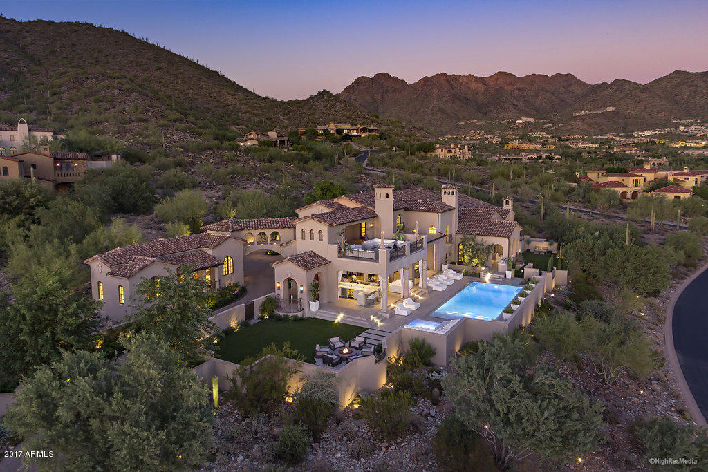 An iconic Silverleaf estate, reborn with a modern style. Built by Geitz Master Builders on one of the best pure, southern exposure view lots, this formal Mediterranean home was renovated by Salcito Custom Homes. At 10,975 SF, this 6 bed (w/detached guest suite), 7 bath home has it all, including 4 en-suite guest bedrooms, beautifully updated chef's kitchen, master suite with spa, sauna, steam, private patio and a closet extraordinaire. Entertain lavishly with a well-appointed open air wine room, game/party room, theater, and outdoor living with 10-top bar and drop down TV, firepit, large spa and stunning zero edge pool that rivals a 5-star resort. The interior seamlessly leads you outside to enjoy the stunning golf, sunset and city light views, whether with family or large groups.