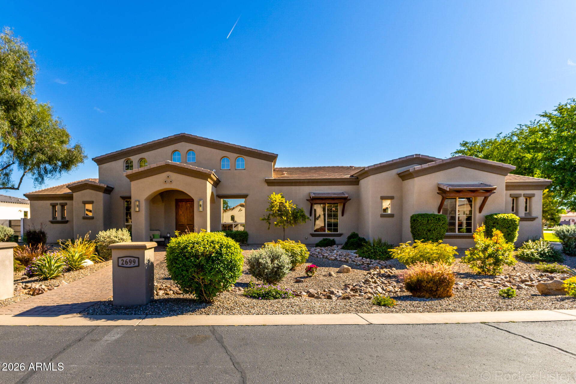 Welcome to this stunning custom home nestled in one of Chandler's most prestigious communities -- Whitewing at Krueger --  perfectly positioned on a serene greenbelt interior lot with coveted southern exposure. With over 4,000 sq ft of thoughtfully designed living space, this meticulously maintained and updated home offers the ultimate Arizona lifestyle. The open floor plan centers around a dramatic great room featuring wood beam ceilings and a striking stone fireplace, flowing seamlessly into a gourmet kitchen with granite countertops, stainless steel appliances, an oversized island, walk-in pantry, and wine room.The split floor plan provides privacy for all, with generously sized bedrooms boasting walk-in closets, en-suite bathrooms, and abundant space to suit any lifestyle. Step outside through 20-ft glass sliding doors to your private resort -- a sparkling pool and spa with gas fire features, a tongue-and-groove covered patio with built-in misters, a sport court, and a park-like yard designed to embrace Arizona's beautiful winter sun while staying cool all summer.

Location couldn't be better -- just 2 miles from the SanTan Freeway and under a mile to grocery stores, gyms, and everyday amenities, putting everything Chandler has to offer right at your doorstep.

This home truly has it all: luxury, space, function, and an unbeatable location.