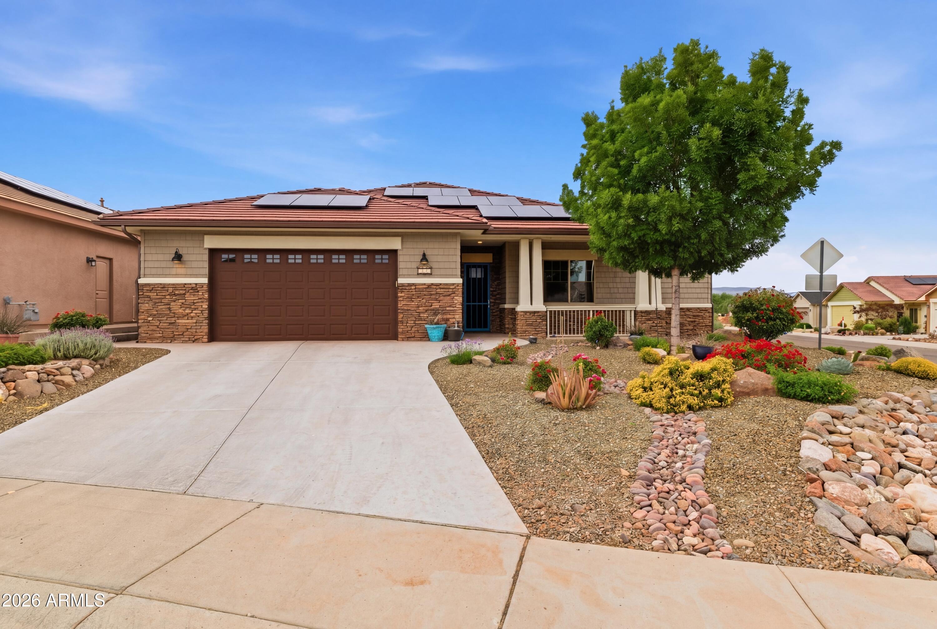 Come and see this zero energy custom home in beautiful Crossroads Subdivision. This home features  10 foot coffered ceilings, tile flooring, granite countertops in kitchen and bath plus an electric fireplace/entertainment center. A fenced backyard with a shed for extra storage and wonderful views of the RedRocks of Sedona from the back patio.A very large spacious garage for cars and toys. It is beautifully landscaped in the  front and back yards.  It is close to all the local amenity's the area has to offer. Come and sit on the front porch of your new home.