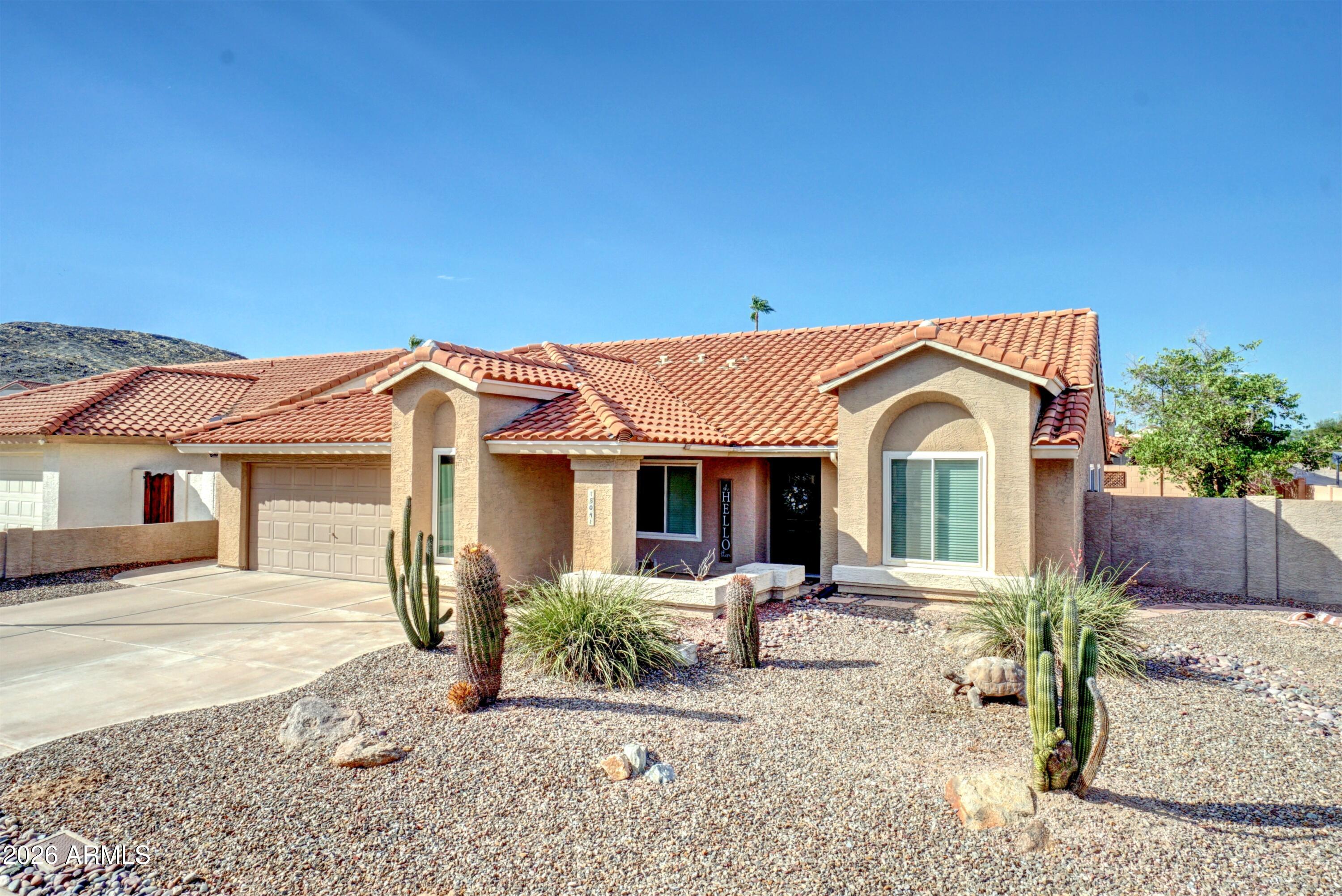 MOVE-IN READY!  Ahwatukee single-level 4-Bedroom, 2-Bath home on a desirable corner lot in a quiet cul-de-sac street!  Flexible Den/4th Bedroom opens to spacious Formal Living & Dining rooms with vaulted ceilings. Inviting Family Room features wood-burning fireplace.  Updated Kitchen offers granite countertops, abundant cabinetry, built-in desk, black appliances, composite granite sink, R/O system; Fridge stays! Both Bathrooms feature granite vanities. Additional upgrades include ceiling fans, light fixtures, window blinds. The Primary Suite provides private access to the backyard & extended covered Patio. The Backyard is perfect for relaxing or gardening, with a paved side yard & concrete raised vegetable planters.  Major Updates: New windows (2023), garage EV Charger hookup(2023), front door (2022), garage cabinets & epoxy floor (2021), gutters (2021), roof & patio roof (2019), water heater (2018), water softener (2018), Trane HVAC (2012).  Located in a welcoming, active neighborhood known for block parties, holiday celebrations, and luminaries. Enjoy walking distance to schools, shopping, and dining, plus access to Mountain Park Ranch HOA amenities including heated lap pool, spa, children's pool, playgrounds, pickle ball, sport courts, ponds, picnic areas, walking paths, and direct access to scenic mountain hiking trails just behind the neighborhood!