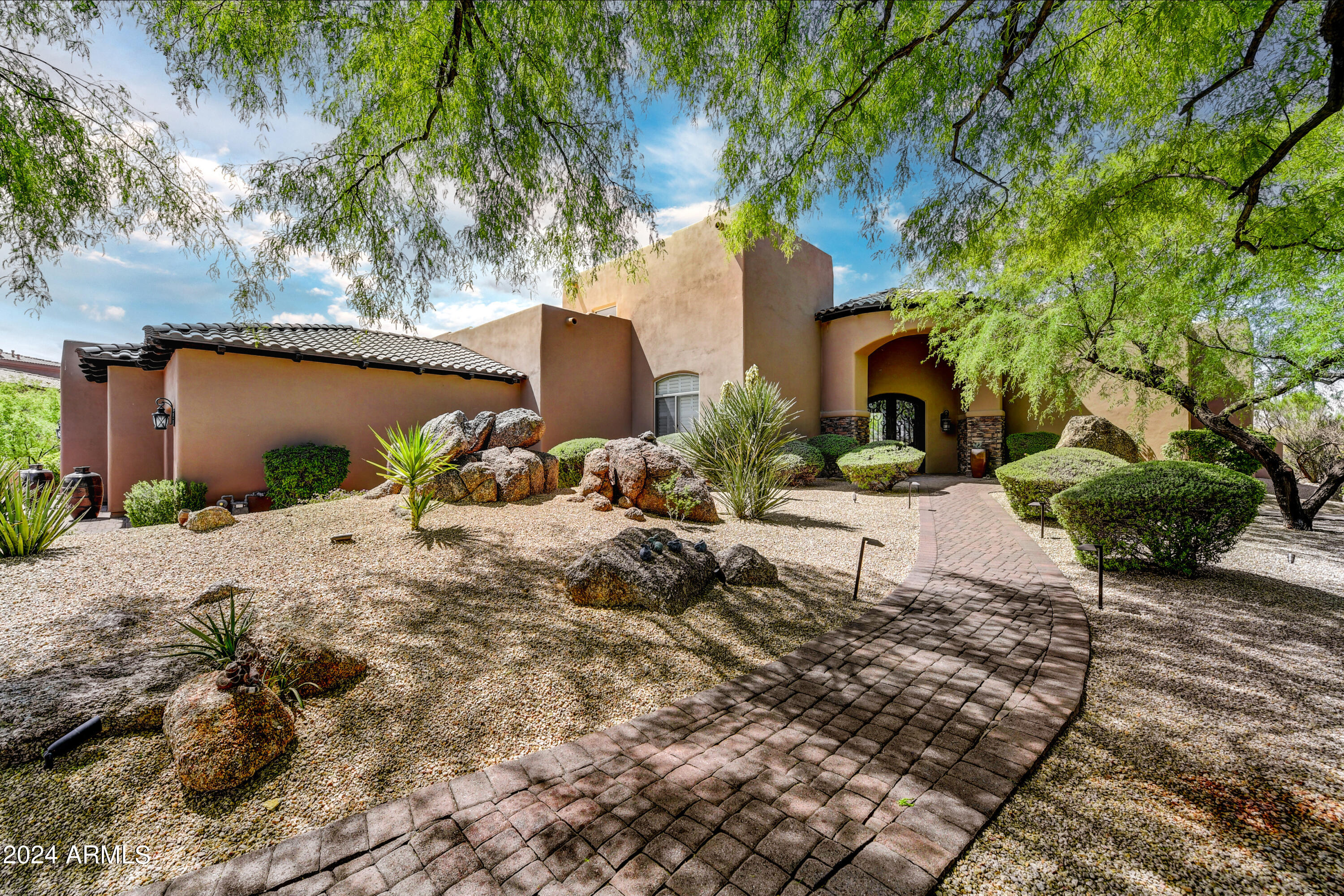 Discover the ultimate in Desert Luxury with this remarkable property nestled along the renowned 2nd Fairway of the Troon North, Pinnacle Course. This SINGLE-LEVEL living home features 4 first floor bedrooms, a private office, and a detached guest casita. The staircase leads you to a loft, where you'll find a balcony offering picturesque Golf Course Views. This home will suit any lifestyle, as it features a gourmet kitchen alongside a wet bar with seating, or venture outside to enjoy the negative edge pool, ample seating areas with a firepit, outdoor grill area, & more! Recent upgrades include a Custom Wine Cellar Wall, Garage Storage Cabinets, and a NEW Roof in 2023!! Embrace panoramic views and lavish amenities for an Unmatched Living Experience. It awaits your arrival!