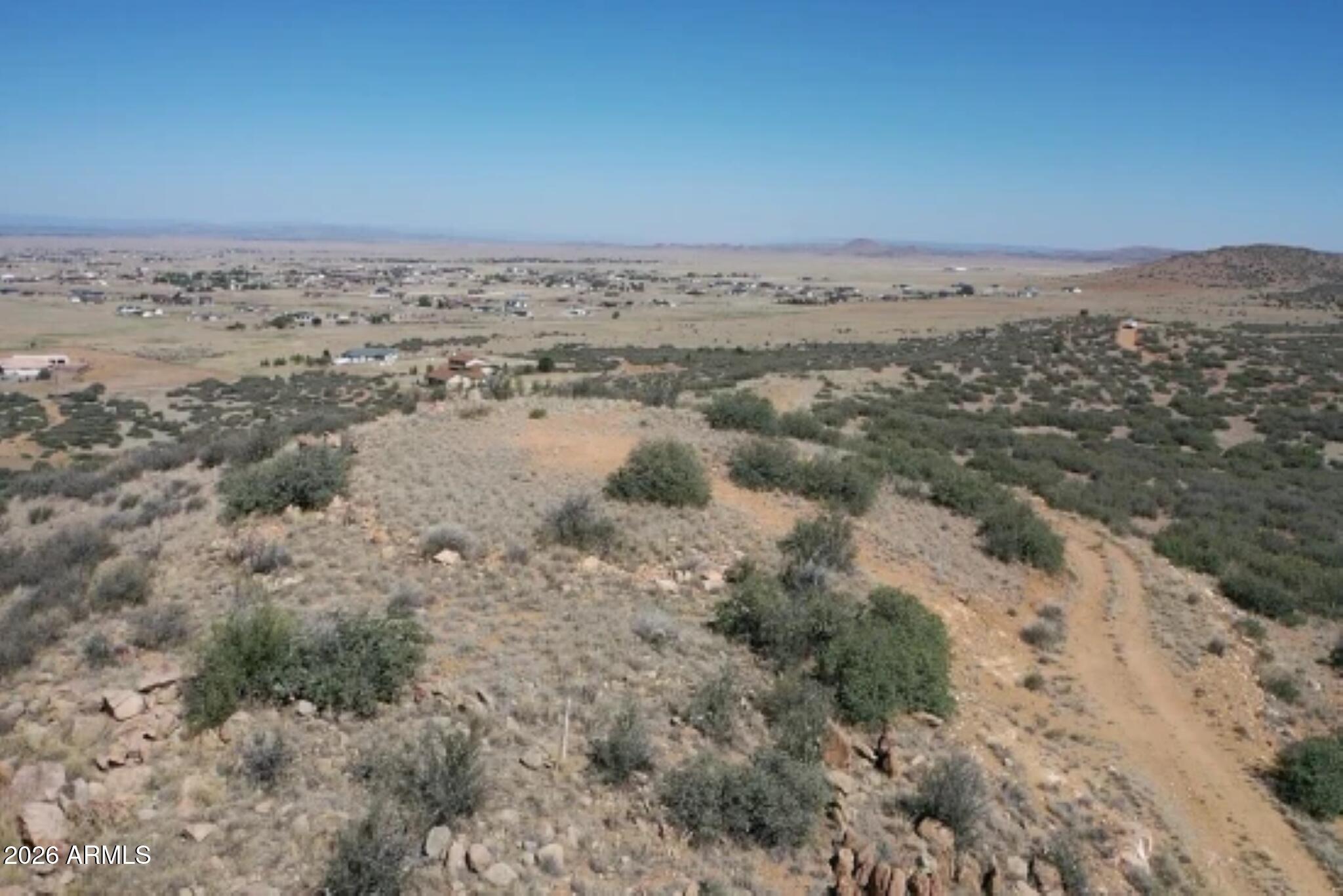 Rare 10.35-acre parcel in the prestigious Prescott Ridge subdivision boasting breathtaking 360° panoramic views of surrounding mountain ranges and open valley floors. This pristine high desert lot is blanketed with native sagebrush and juniper, offering natural beauty and total privacy.