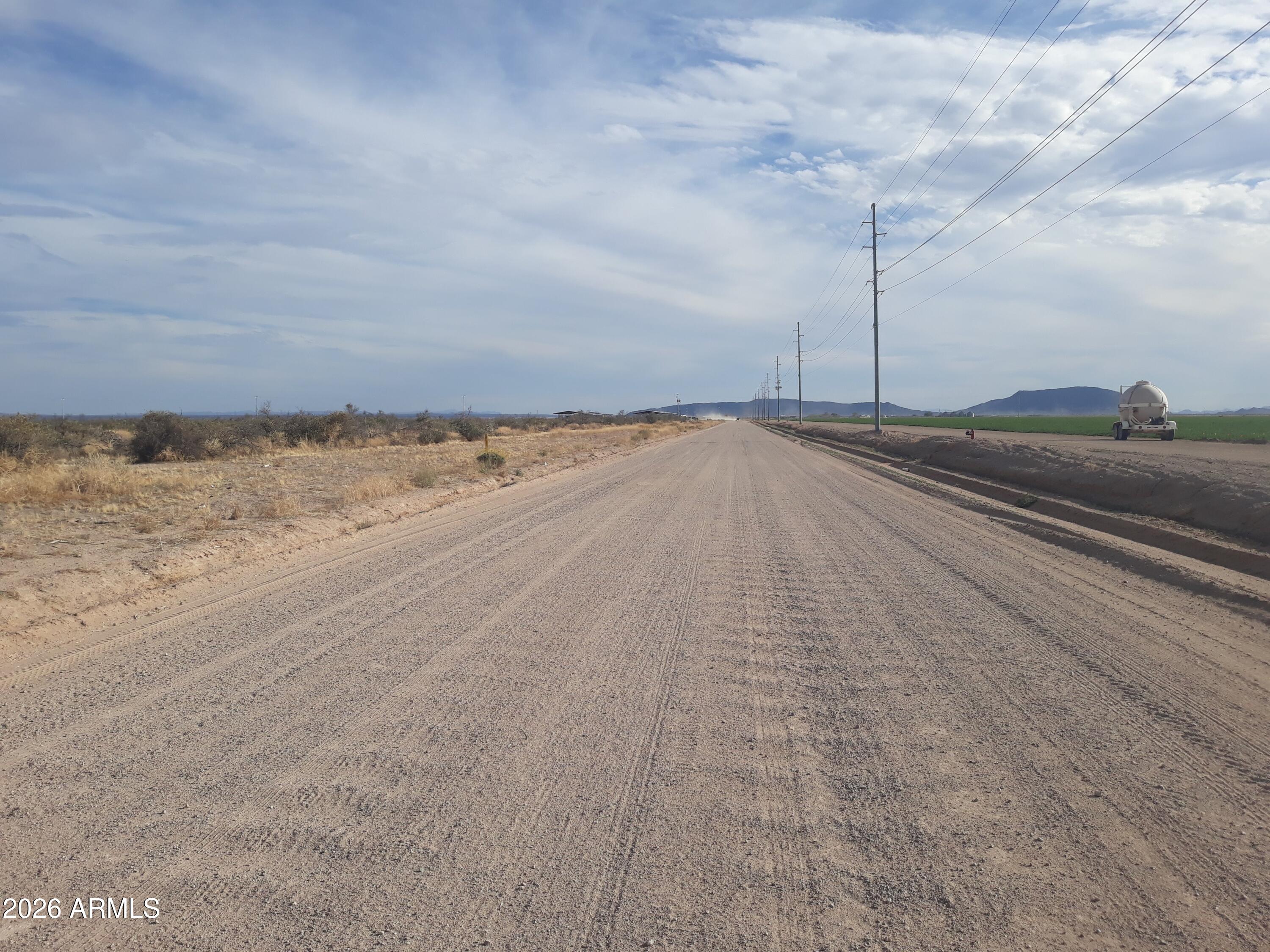 Welcome to Hyder! 4.7 acres of flat land with POWER and WATER very close by. This lot is rectangular and the area itself has incredibly level topography. All of this combined with falling within Maricopa county Lines! Perhaps this lot's hidden value is its close proximity to Tonopah. If you go north about 17 miles you will see that Tonopah begins where this area ends. The difference is you will be paying far more than this price for only 1 acre anywhere near the heart of Tonopah. As you approach this property you should be able to see beautiful green farmland in every direction. You will also see a new home to the east of this lot as more people are taking notice to the Hyder area!  This area is known for its irrigation possibilities.