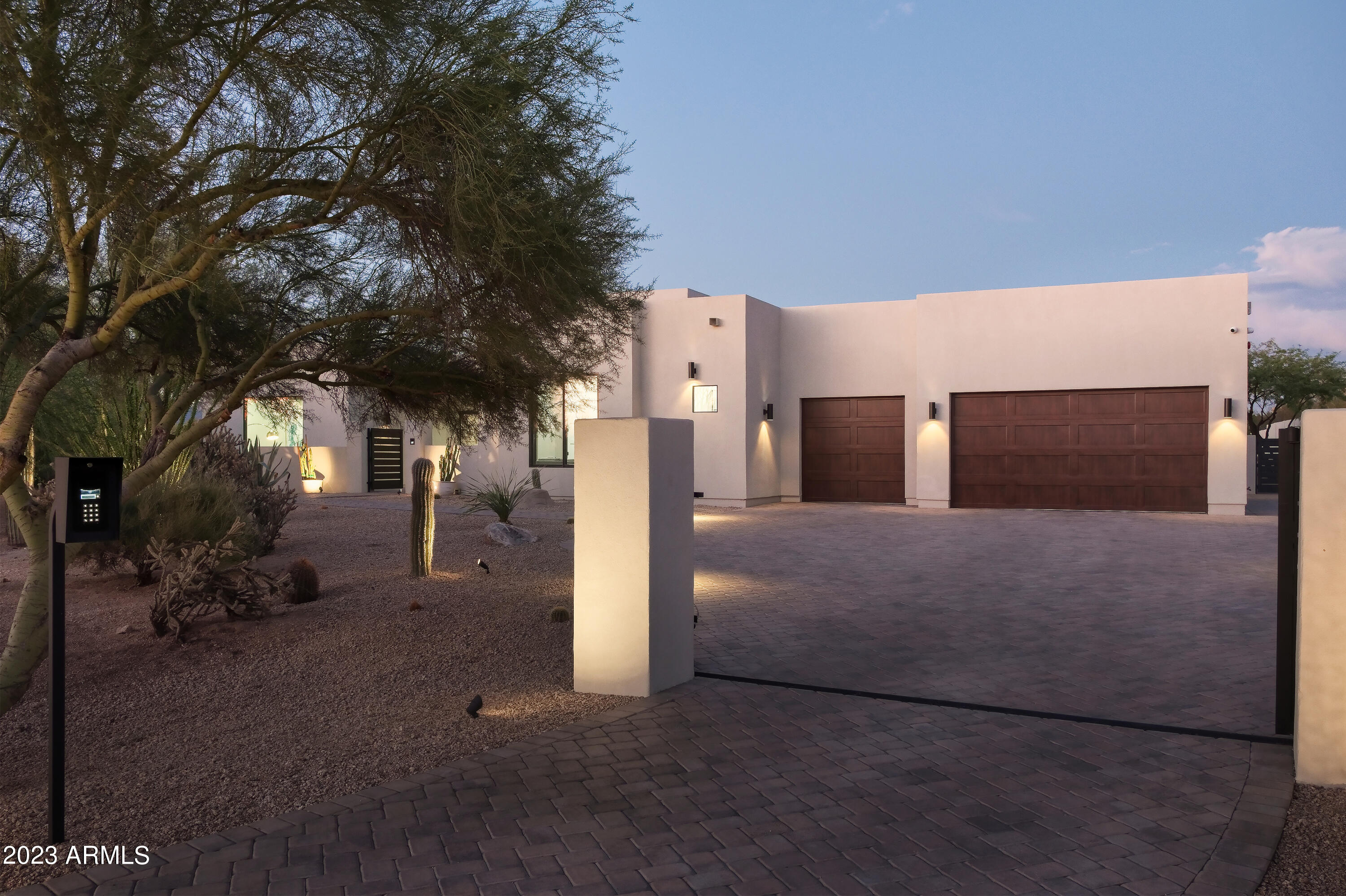 Welcome to almost new construction on 1.5+ acres in N Scottsdale! A private gate opens to a massive driveway where pavers in a herringbone pattern lead to an oversized 5-car tandem air-conditioned garage. You enter the home through a private courtyard that offers access to your 486 sq ft casita. The main house has a bonus den and an office with a custom studio glass wall. Indulge your inner chef in the state-of-the-art kitchen, complete with Sub-Zero appliances along with a double pantry. The resort-style backyard is a true haven, boasting a bbq and hibachi area nestled under a custom pergola.  The star of the backyard is the elevated 786 sq ft Pool house and gas heated pool/spa.  This east/west exposure is bordered by NAOS to the north which offers spectacular views of nearby mountains.