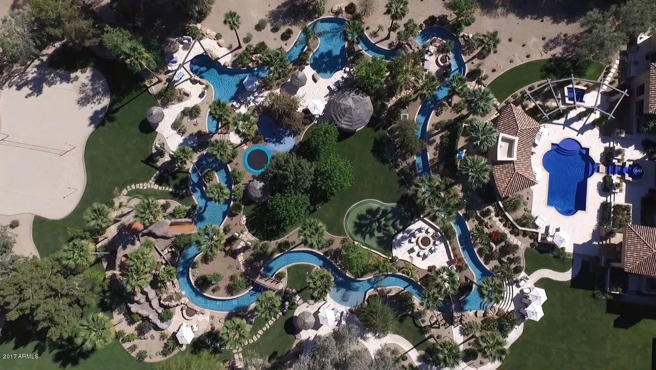 Bramasole: Enjoy your own resort!  Privacy, luxury & relaxation in the heart of the Valley.  Situated on 4+ acres of lush landscaping boasting over 15,000 SF of elegance featuring a 3,000-bottle wine cellar, chef's kitchen, library, high-tech media room, exercise room, and an oversized 9 car garage!  The outdoor oasis rivals any resort. Dip into your beautiful saltwater pool & spa, entertain with seating for 120 of your closest friends while floating in your 150,000 gallon lazy river with a 30 FT water slide, rope swing, splash pad, volleyball court, firepits and putting green.  Enjoy your outdoor commercial kitchen, his & her locker rooms and a separate guest house, in addition to a caretakers cottage with an additional garage!  Your dream estate awaits YOU...