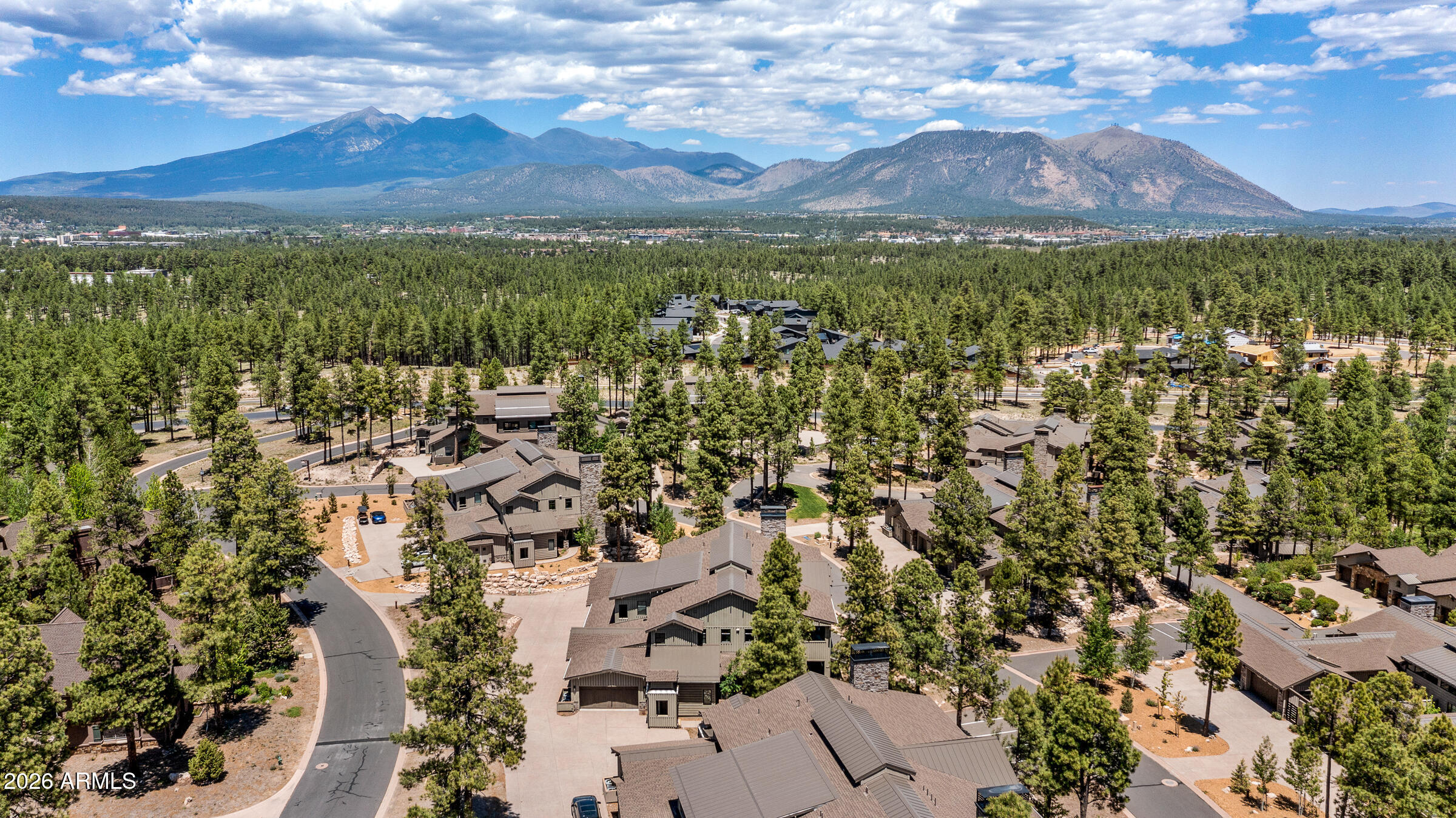 Experience luxury Mountain living in this exceptionally sought-after ground-level condominium, designed for effortless indoor-outdoor entertaining and refined comfort. Built in 2021, this stunning residence showcases a bright open-concept floor plan, a private guest Casita, and an expansive walled wrap-around patio that creates the perfect dog run! Every detail has been thoughtfully upgraded with high-end designer finishes and premium appliances, including a Sub-Zero side-by-side refrigerator, Wolf oven/range and built-in microwave, striking Quartz countertops, and an impressive 7-foot kitchen island with bar seating ideal for gathering with family and friends. The sophisticated living space is highlighted by dramatic tongue-and-groove ceilings, exposed wood beams, and an extended floor-to-ceiling stone fireplace wall featuring a sleek linear gas fireplace. Entertain in style at the custom-built-in wet bar complete with a Sub-Zero wine refrigerator, copper bar sink, and elegant glass-front cabinetry. Luxury continues throughout the home with automated window coverings in every room, including blackout shades in the serene primary suite, as well as top-down/bottom-up insulating shades that perfectly blend comfort, privacy, and style. This is elevated resort-style living at its finest