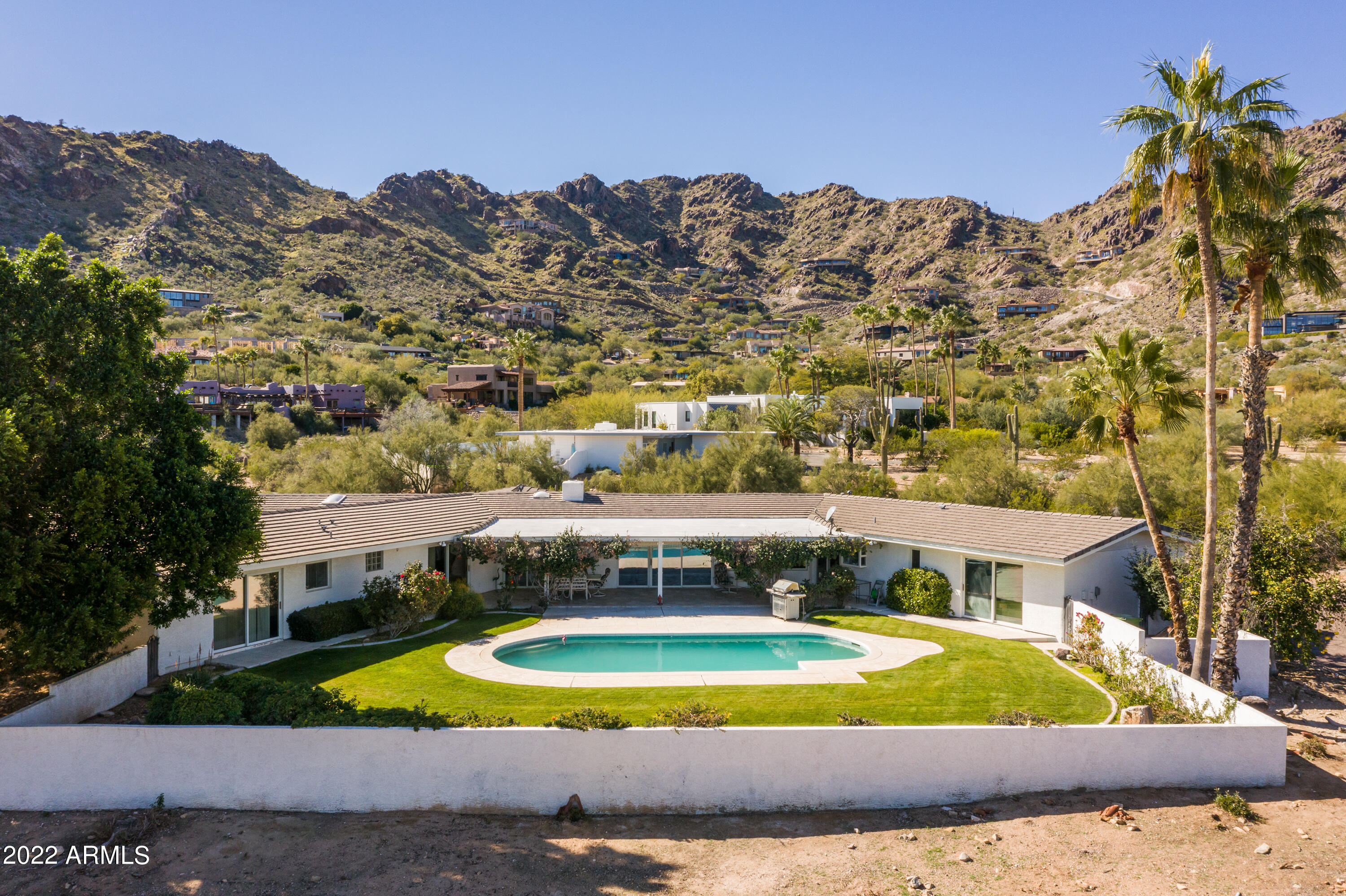 Surrounded by multi million dollar Estates, this rare find is nestled on the North side of Mummy Mountain in the highly prestigious community of Paradise Valley. You can enjoy this custom built home in it's current charming mid century state - or build brand new. Either way this is an amazing location to take in the best 360 degree panoramic views our city has to offer. Dream big and don't miss this one of a kind opportunity in a market that is showing no indication of slowing down. Home was recently updated with new paint and carpet throughout.