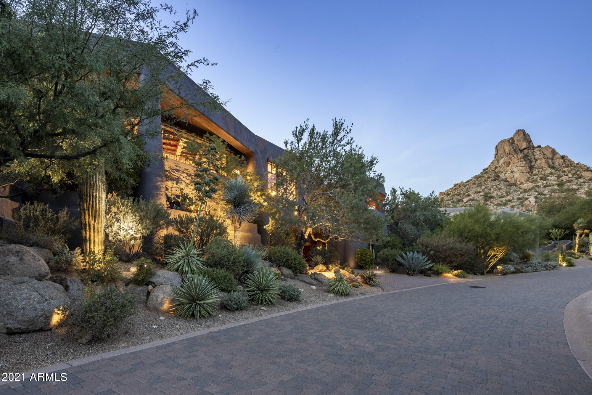 Contemporary southwest custom hillside Desert Highlands villa, with spectacular mountain views, is an architectural masterpiece built in 2008 with the upmost level of quality construction & craftsmanship. Meeting all 26 criteria of the City of Scottsdale Green Build Program, this ''Green Home'' has a meticulous attention to detail offering the very finest of finishes to include Autumn blend flagstone, solid wood beams cut from expired standing timber shaped on site & kilned for 30 days in Holbrook, Arizona before installation, massive granite slabs, hand carved front entry & interior doors, custom cabinetry & hardware, Wolf gas cook top/oven, SubZero refrigerator, 2 Miele dishwashers, custom hammered metal vent hood & bar with wine tower, beverage drawers, sink & ice maker.  Built of EF concrete block construction & finished with quality details that exude the contemporary feel of the desert southwest, this stunning home was designed to capture the breathtaking views, abundant rock crossings, natural desert landscape & views of the Jack Nicklaus championship golf course throughout the living space.  Whether entering from the elevator at street level or the hand carved front door, elegance emanates in every detail of  the open floor plan.  Retractable patio doors open to an outdoor living space with heated pebble finish pool, spa & water feature for enjoying all the seasons of Arizona. Patios wrap around the property with fire elements or fireplaces at each location as well as the main entrance for enjoying cool Arizona desert evenings.  The split master suite with viewing patio &  master bath with endless private views of rock crossings & Pinnacle Peak is a tranquil retreat.  2 separate guest suites create a resort experience for guests with both offering individual sitting patios, en suite baths, walk-in closets, stone & opulent finishes.  The separate casita with en suite bath, sitting room & walk-in closet is tucked away for privacy at street level.  This custom home is the epitome of the desert lifestyle combining exquisite beauty with green functionality.  Desert Highlands world class amenities include a Jack Nicklaus championship golf course, award winning clubhouse featuring ''Jack's'' gastropub, state of the art fitness center, Highlands Racquet Club with grass, clay courts, pickleball courts & more.