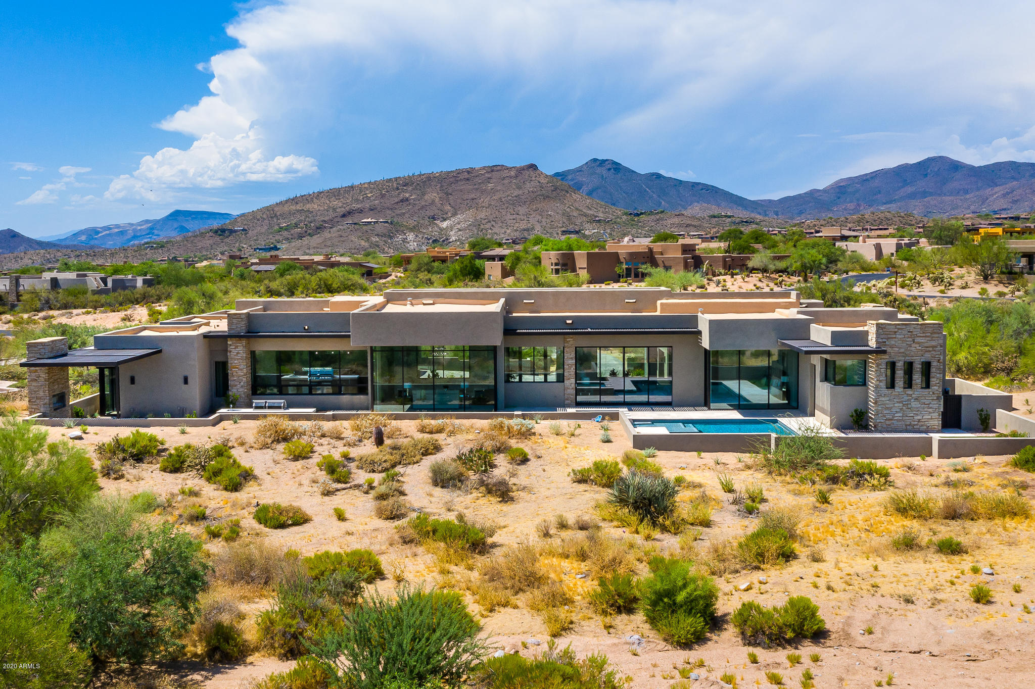 Experience Stately Living from this brand new, SINGLE LEVEL Desert Contemporary Transitional masterpiece with NO INTERIOR STEPS in the most popular Golf Community in Sunny Scottsdale! Enjoy incredible sunsets and city lights from the safety and security of this 24 Hour Guard Gated Desert Mountain community! Take advantage of Arizona's indoor/outdoor living from this spectacular North/South facing property with designer finishes and spectacular amenities. The 5,709 Sq Ft house features a stunning Master Suite, 3 Ensuites, bonus room and open, light, and bright living areas with floor to ceiling glass and retractable glass wall. The Guest House offers a full Kitchen, Great Room, Garage, and Bedroom. Schedule a private tour today.