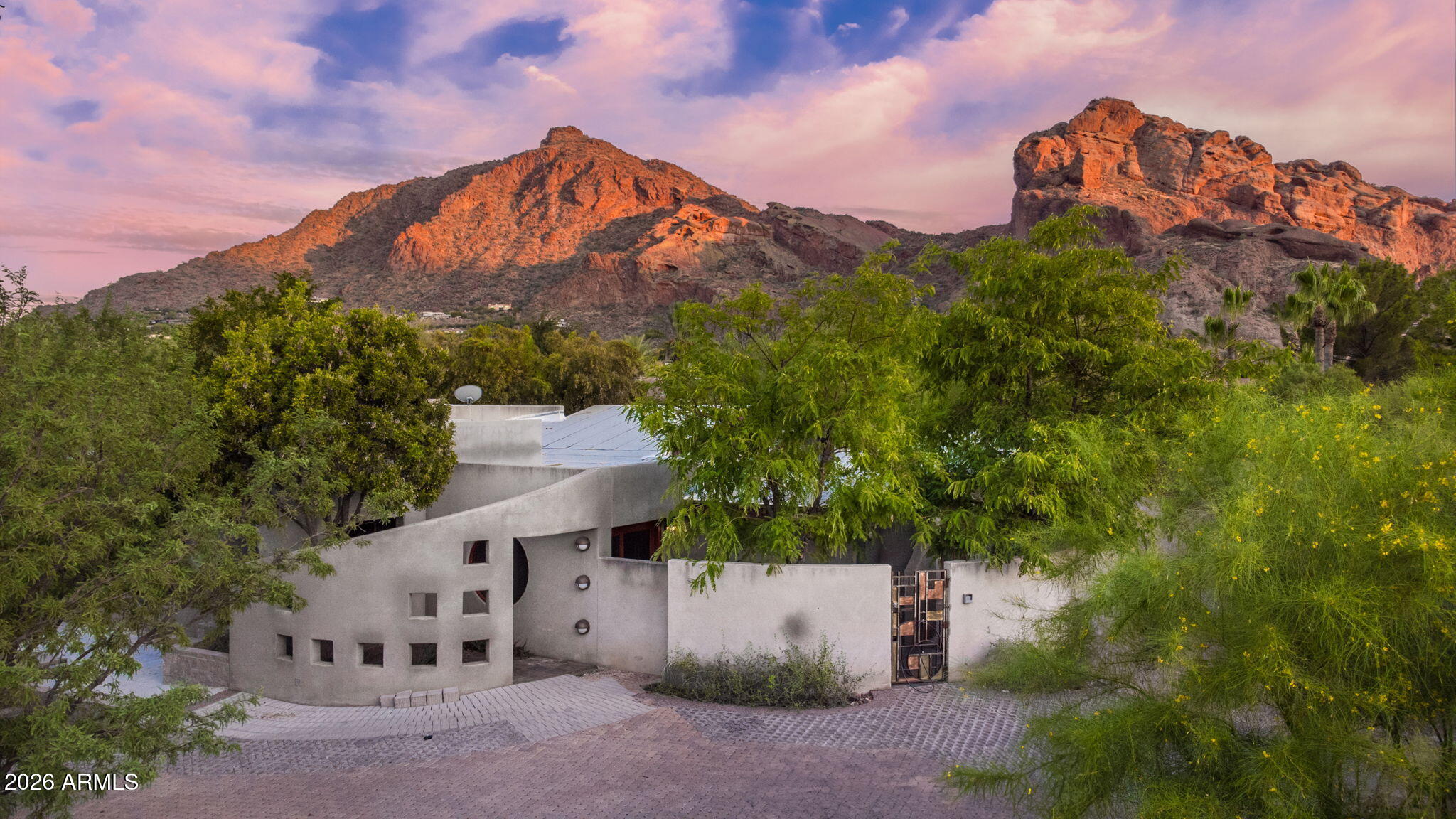 A rare opportunity to bring to life one of Paradise Valley's most thoughtfully conceived architectural designs.  Designed by acclaimed Chen + Suchart Studio, this fully permitted residence is a study in restraint, light, & connection to the desert landscape. A sequence of sculptural courtyards, framed garden moments, and sun-washed passageways unfolds throughout the home, creating an experience that feels both intimate and expansive.  Inspired by the surrounding desert & mountains, the architecture embraces natural textures, filtered light, and seamless indoor-outdoor living. Oversized windows frame living works of art, while tranquil outdoor spaces invite moments of reflection beneath Arizona's endless skies.  Set on a premium private lot with unobstructed Camelback Mountain views, the property offers a rare balance of architectural significance, serenity, and modern luxury.