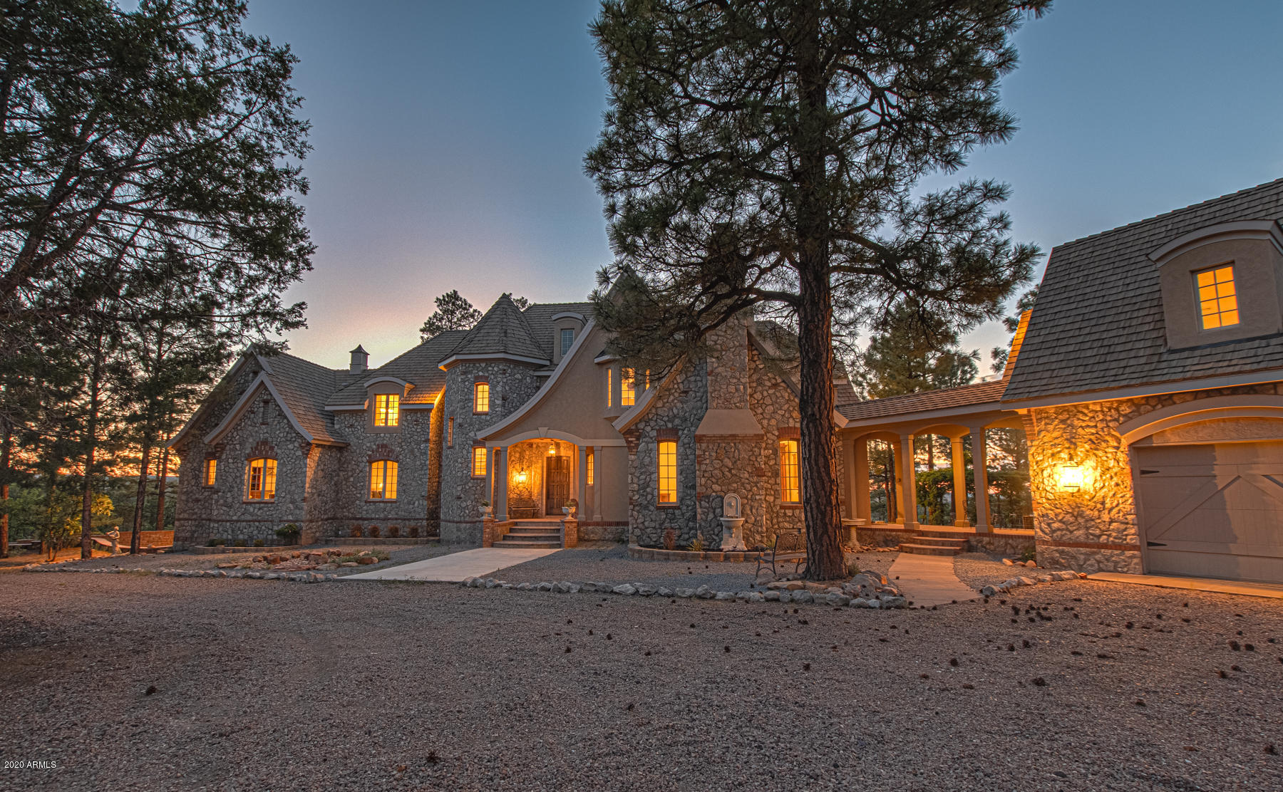This one of a kind Chateau in Show Low could be yours! Situated on just under 40 acres, you'll enjoy privacy while maintaining close access to local amenities. Walk through the well treed grounds to find yourself in the open and inviting foyer. Fantastic natural lighting and high ceilings make for a welcoming space to relax. The custom kitchen, with high end appliances and plenty of prep and cabinet space, is truly a chef's dream. Whether you choose to take a seat at the breakfast bar, breakfast nook off the kitchen, or formal dining room, the serene setting is sure to delight. Take your pick of gorgeous master suites on the main or second level of the home. There are four choices of guest bedroom in addition to the master suites, ensuring that your guests will feel comfortable. Take in the impressive views while you work in the office space. Step down to the lower level and pull up a chair at the wet bar. Savor a sip of your favorite bottle in the elegant wine storage area. From the main level, walk through the breezeway to the attached 3 car garage. Above the garage, a large bonus room offers tons of potential for guest quarters, a game room, groundskeeper accommodations, and so much more! Take your time to take in the beauty, both man made and natural, surrounding this space. Vines intermingle with the pergola outdoors, making for a dreamy seating area, while the outdoor stove provides warmth and ambiance to your gatherings. Stunning views can be enjoyed from any point on the property. This is truly a one of a kind property, set aside the time for yourself to take it all in, opportunities of this caliber do not arise often. Additional parcel of 20 acres available for $499,000. Assessors# 409-32-001D