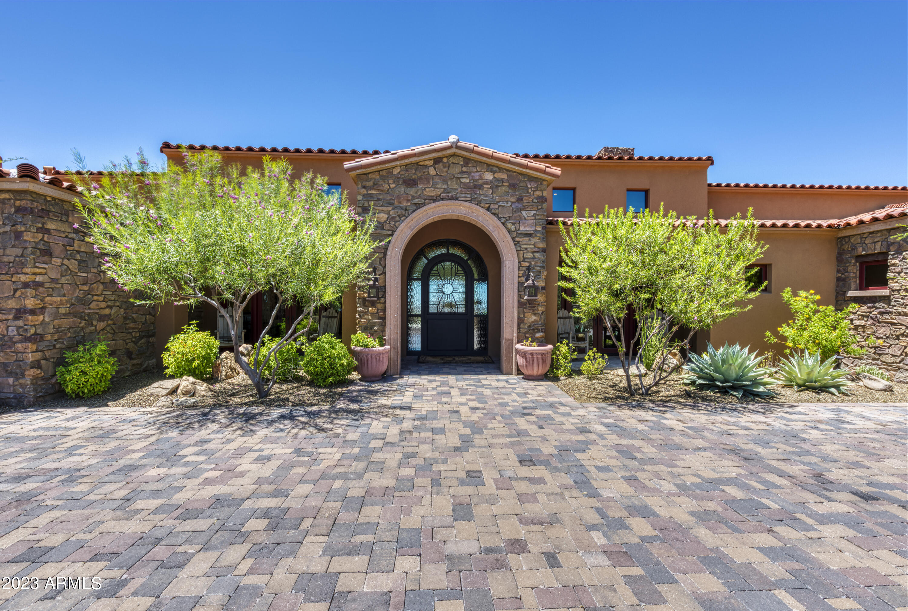 GOLF MEMBERSHIP AVAILABLE!  Exceptionally beautiful custom home in Saguaro Forest looking down the 10th of Chiricahua course.  Fully solar home!  Interior has just been completely repainted. Home is a charming ''Santa Barbara'' style with wood floors/ wood molded windows and doors; French and sliding doors in abundance bringing the outside in.  Main house has 3 ensuite bedrooms; amazing chef's kitchen w/stunning coved brick ceiling; wine refrig; built-in coffee station, etc. Great room stacking doors bring outside in; lovely office; heated & cooled exercise room; 4 extra large garages; multiple storage rooms.Casita has 2 ensuite bedrooms/sitting room & kitchen.  Wonderful entertaining patio w/separate outdoor kitchen & bath; fire pit w/bunco seating; exterior upper level viewing room.