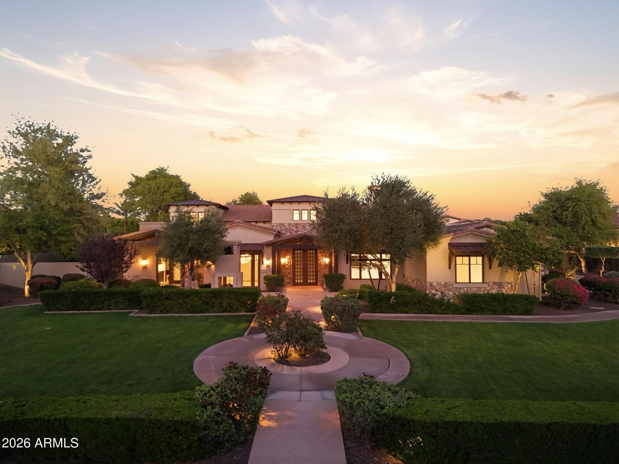 Welcome to Copper Creek Estates, an intimate gated community where privacy and prestige converge. As you arrive, you're greeted by lush, meticulously curated landscaping that immediately sets a tone of quiet opulence. This home is more estate than residence, a sweeping driveway unfolds, guiding you to the garages, including a substantial RV garage and RV gate access, effortlessly accommodating up to eight vehicles and recreational toys.
Thoughtfully designed landscaping and private courtyards off the front dining room and office provide a bespoke introduction, with refined outdoor moments that elevate everyday living in ways you didn't know you were missing. Step through the entry into a grand foyer where soaring double-height ceilings and intricate floor detailing create a striking first impression. Your gaze is drawn straight through the home to the resplendent backyard beyond with a seamless sightline that invites you forward into the great room. 
Here, a full wall of pocketing glass doors dissolves the boundary between indoors and out, while a stately fireplace anchors the space with warmth and understated elegance. The great room flows effortlessly into a truly curated culinary space. Outfitted with a Wolf four-burner gas range with teppanyaki grill, industrial-grade vent hood, pot filler, Sub-Zero refrigerator and freezer (including a glass-front display), and double-wall ovens, this kitchen is both functional and exquisite. At it's center, an expansive island offers both presence and purpose, while a custom butler's pantry, complete with wine refrigeration and abundant custom storage connects seamlessly to the dining room. There, refined chandeliers, picture lighting, and French doors open to a private courtyard with a double-sided fireplace, creating an atmosphere that is both intimate and grand, entertaining here is nothing short of elevated.
The home's split floor plan ensures privacy and intentional design. One wing features a sophisticated office with its own courtyard access and connected powder room. Down the hall, the primary suite is a sanctuary of light and comfort, with direct access to a covered patio and a fireplace that adds a layer of quiet luxury. The ensuite bath is nothing short of inspired: a large freestanding tub, an oversized walk-in shower with multiple showerheads and a rain shower feature, and softly diffused natural light create a setting of serene indulgence. Dual water closets, generous vanities with custom storage, a dedicated makeup space, and an expansive walk-in closet with stacked washer and dryer complete this private retreat.
The opposite wing hosts beautifully appointed guest suites, each with walk-in closets and ensuite baths, offering comfort and autonomy for family or visitors. A versatile den provides space for a media room, game lounge, or private retreat, while an additional powder room and a well-equipped laundry room; with raised washer and dryer, utility sink, and extensive storage, add everyday convenience.
Throughout the home, multiple access points lead to the outdoor living spaces, where the experience continues. The backyard is a true extension of the home's opulence, featuring a covered patio with built-in heaters and commercial-grade misters, a wet bar with beverage refrigeration, and a stunning pool with raised spa. The covered gazebo with a fireplace invites evenings under the stars, while mature landscaping, fruit trees, and a dedicated fenced pet area ensure both beauty and functionality.
And then, the showpiece: a detached casita designed for extraordinary entertaining. A pass-through window with extended bar seating sets the stage, while inside, the space unfolds into a fully equipped, restaurant-caliber experience; complete with full grill, restaurant-grade smoker, plenty of prep areas, sink, dishwasher, soda tap, and beer taps that lead to an industrial walk-in refrigerator. The adjoining lounge area features its own pocketing glass wall, additional bar, and full bathroom, creating a private, immersive environment that redefines at-home hospitality.
Additional features include a full Lutron lighting package, a whole-home, 21-zone Sonos sound system, delivering a seamless and immersive audio experience throughout. The estate is further enhanced by fully integrated mechanical and electrical systems, allowing for effortless remote operation and control, bringing modern convenience and precision to every aspect of the property. This is more than a home, it is a meticulously crafted, palatial living experience where every detail has been considered and every space designed to impress.
