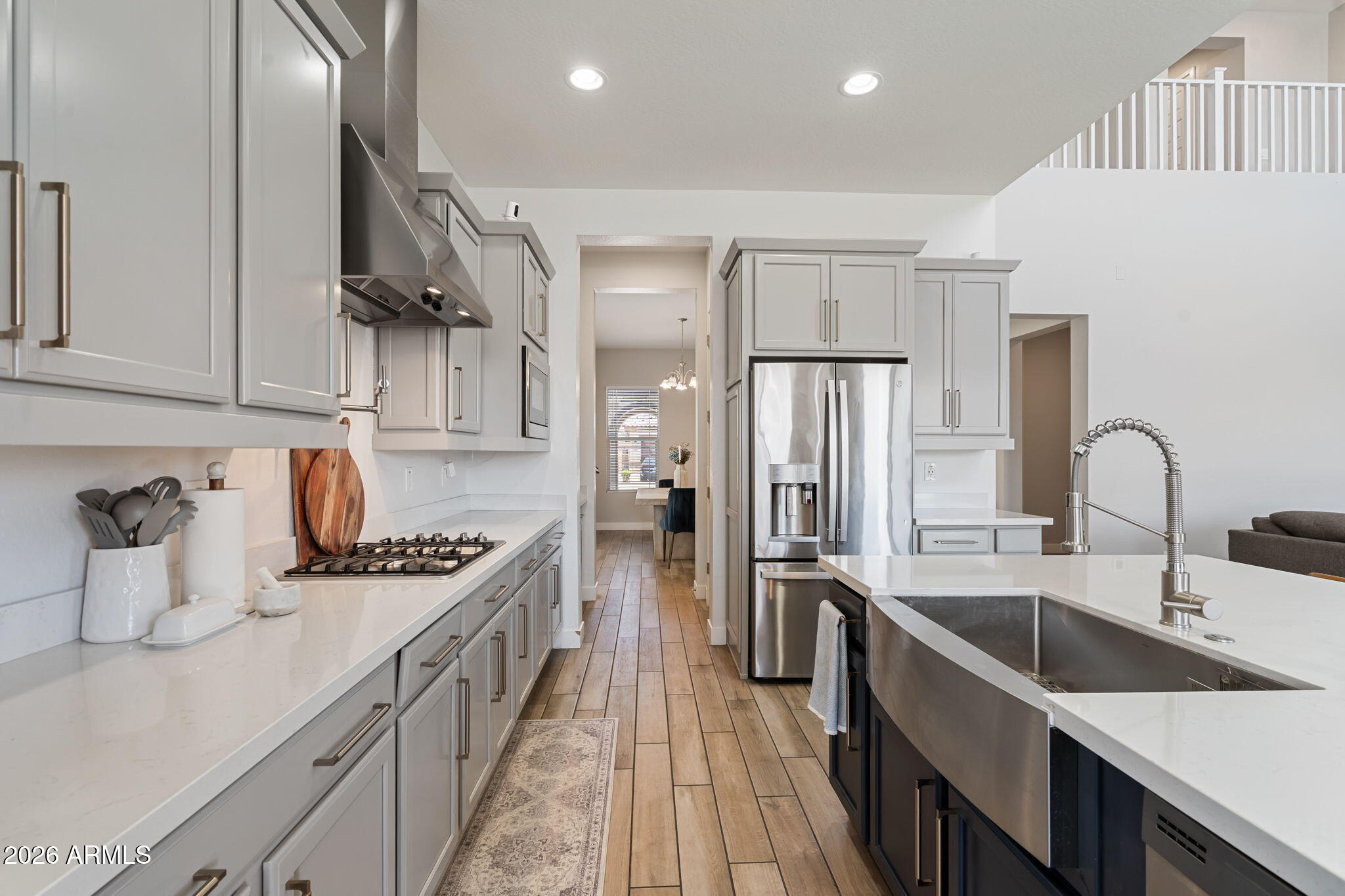 Seller offering $10,000 towards buyer's closing cost. 5 bed, 4 full baths, OWNED solar,  3-car garage, RV gate, and a lot with room to actually use.  The kitchen is the heart of this home, with chef's kitchen and lots of upgrades. Quartz counters, double ovens, and a POT FILLER over the gas range. The butler's pantry keeps things out of sight when you're entertaining.
High ceilings and impact windows bring in natural light all day, and it really shows off the wood-tile flooring throughout.
Downstairs you'll find a full bedroom and bathroom, perfect for guests or multigenerational living, plus an office nook for anyone working from home. Upstairs, the master suite includes a rain shower that feels more spa. Backyard has artificial grass and pavers for easy maintenance.