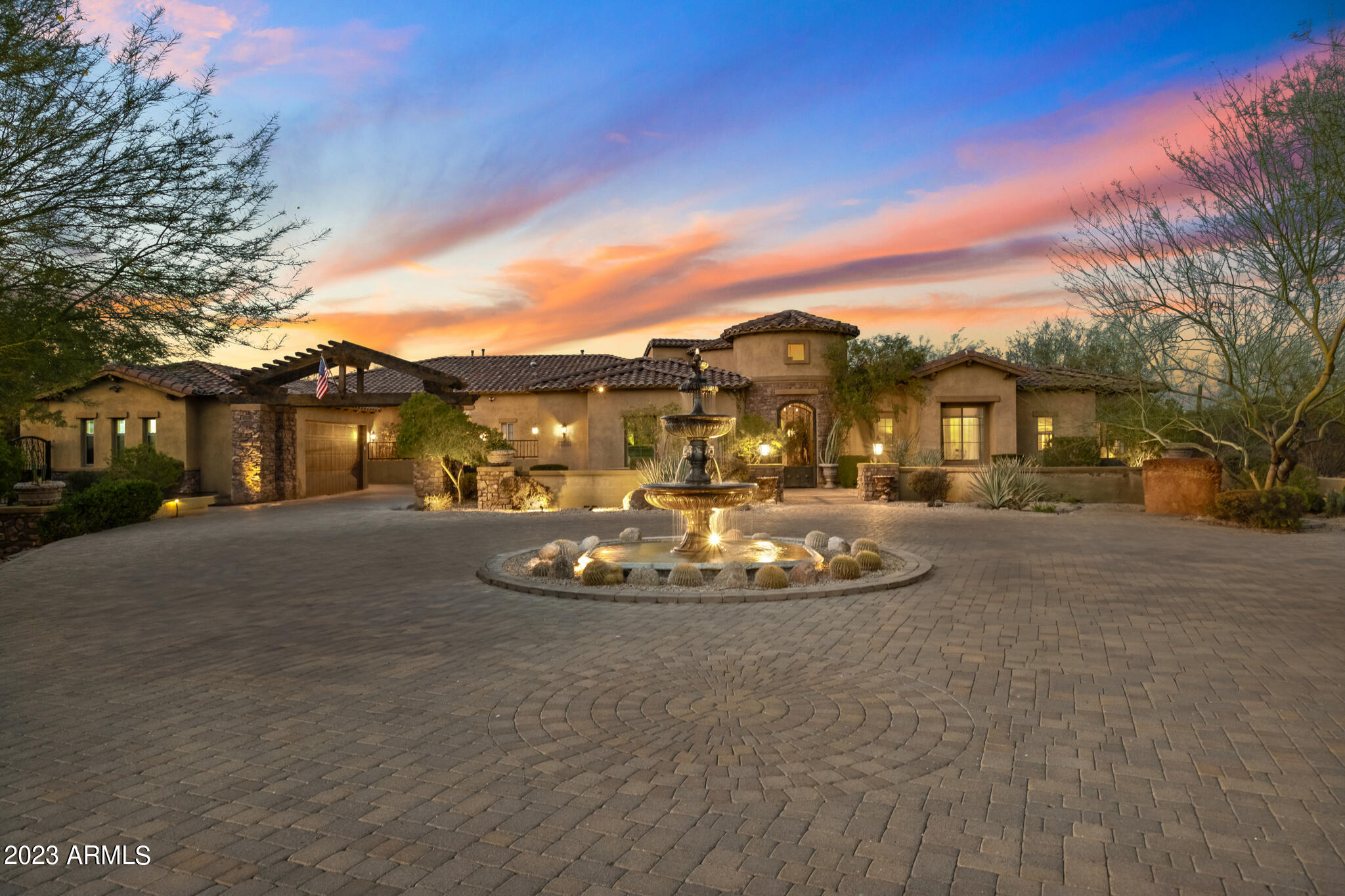 Explore the pinnacle of elegant lifestyle within this extraordinary Saguaro Estate home, positioned on an expansive interior lot that extends over 2.5 acres. This residence exemplifies unmatched luxury and seclusion, complete with its own private gate.

Outdoors, over $1 million has been invested in crafting an unparalleled haven. Immerse yourself in leisure with a plethora of amenities, from putting greens for the golf enthusiast and a Teppanyaki grill for culinary adventures, to a wood-fired pizza oven for gourmet delights. A fully equipped outdoor kitchen and bar invite lavish entertaining, complete with an ice maker, fridge, and BBQ grill. Indulge in luxurious living with split bedrooms that offer unparalleled privacy. The inclusion of a dedicated office space caters to your professional needs, while the secondary wing, featuring a separate family room, provides versatile spaces for relaxation and leisure. Plus, the convenience of en-suite bathrooms for nearly every bedroom ensures the utmost comfort. Relish in the sheer grandeur of the master suite, complete with a delightful breakfast room for intimate mornings. The master boasts an extravagant touch with not just one, but three walk-in closets, offering an abundance of storage for your personal treasures. In addition, a cozy guest house featuring a private bathroom and fully-equipped kitchen, ensuring a comfortable and convenient retreat for guests. 

Nestled within the realm of refined elegance, this home's interior is adorned with exquisite faux finishes, exuding opulence from every corner. The imported Turkish Travertine flooring, meticulously sourced from the heart of Turkey, imparts a distinctive and captivating charm to both the interior and the backyard living space. Elevate your leisure time with a private in-home cinema, where seamless, uninterrupted screening experience meets the tranquility of soundproofed serenity.

As the sun sets, the enchantment continues with starlight pool projections enhancing the ambiance, while water features provide a touch of serenity with their soothing "Waterwall" modes. A rear patio movie projection system transforms the pool area into a captivating outdoor theater. This is your opportunity to own a residence where contemporary living meets timeless elegance.