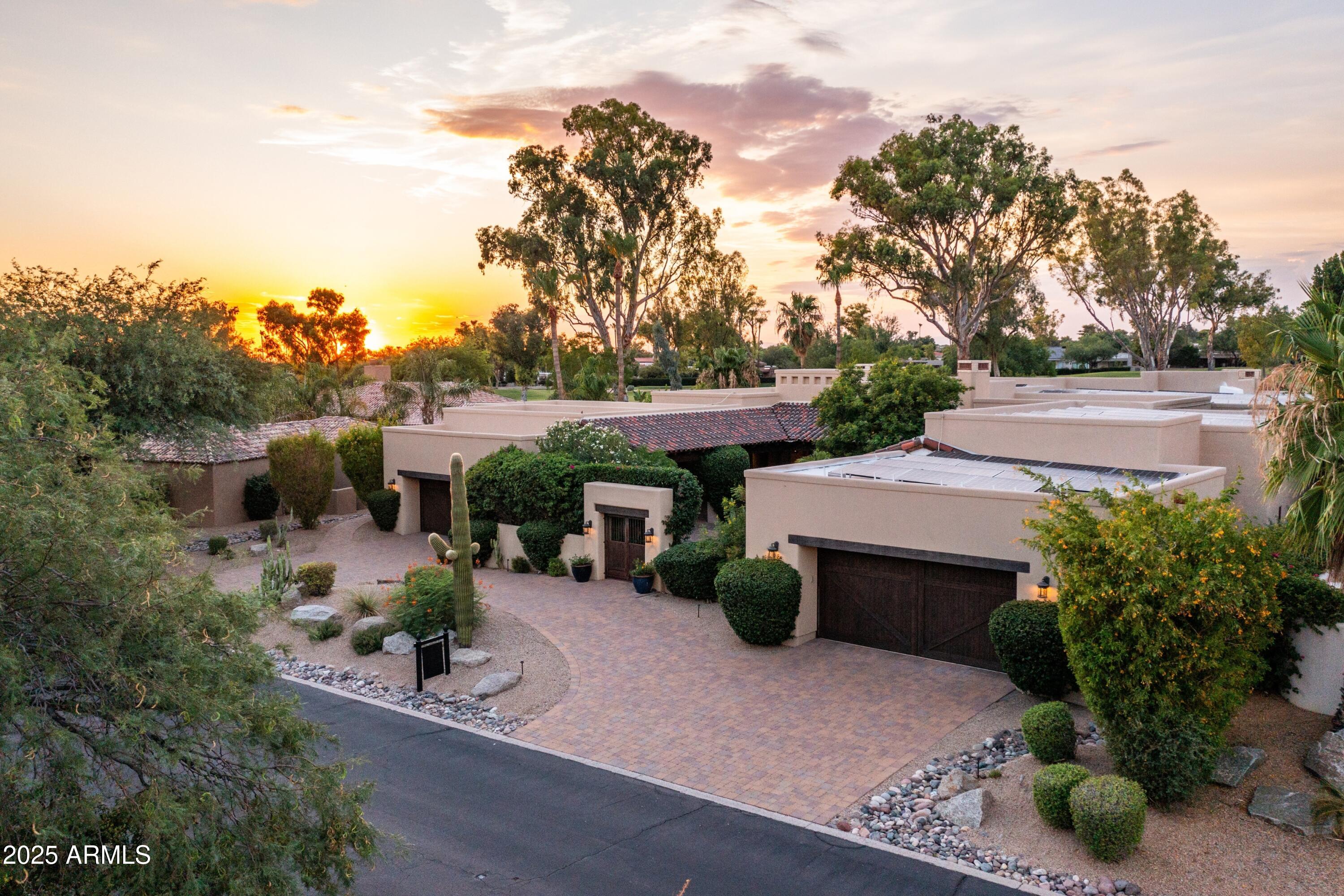 Meticulously refreshed and rejuvenated, this updated Pinnacle Peak Country Club Estates home offers the quintessential North Scottsdale lifestyle with a luxurious organic residence designed for entertaining and intimate gatherings alike, nestled on a golf course lot backing to 3 signature holes of private Pinnacle Peak Country Club golf course. Light and bright finishes including new quartzite Taj Mahal countertops, new Joalice tile backsplash, built-in Miele coffee maker and updated custom lighting hint at the elegant attention to detail, catering to modern living while preserving timeless charm. Open concept living throughout the 6191 square foot residence is optimal for a family, combining private suites including a master retreat with steam shower and second laundry, separate casita that lives as the fourth bedroom or studio, exercise room, media room or detached office space with tranquil spaciousness and areas of relaxation featuring 5 gas fireplaces with custom ironwork.  The elegant residence centers around exceptional outdoor living offering an expansive covered patio with stone surround fireplace opening to multiple areas for lounging with misters and an elevated patio overlooking the custom heated pool with water features, perfect for warm summer days. Abundant greenery reveals views of the private golf course fairways while retaining privacy, creating a tranquil setting ideal for unwinding after 18 holes. Life in this private community offers an exclusive experience of the finer things in life with the perfect balance of accessibility and seclusion.