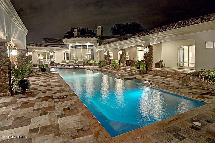 Easy Arizona living are words that capture the true essence of this tucked away estate nestled in the town of Paradise Valley. Extensive remodel by Eagle Luxury Prop. in 2014 transformed this home to market perfection. True privacy is achieved due to location in small 9-home gated subdivision of Ironwood at Camelback Country Club. Home is located on the 7th tee of the Padre Golf Course at Camelback Golf Club. Features and Upgrades include but not limited to-New HVAC(condensers and air handlers) systems in the main house, New Wolf/Sub-Zero appliances, New Hardwood Flooring, New Cabinetry throughout the main house, 60 yard turf football field, 16-seat theater room, exercise/yoga room, heated/cooled patio, heated pool w/ spa, 5-Car Garage and outdoor kitchen. Prev. Home to actress Emma Stone.
