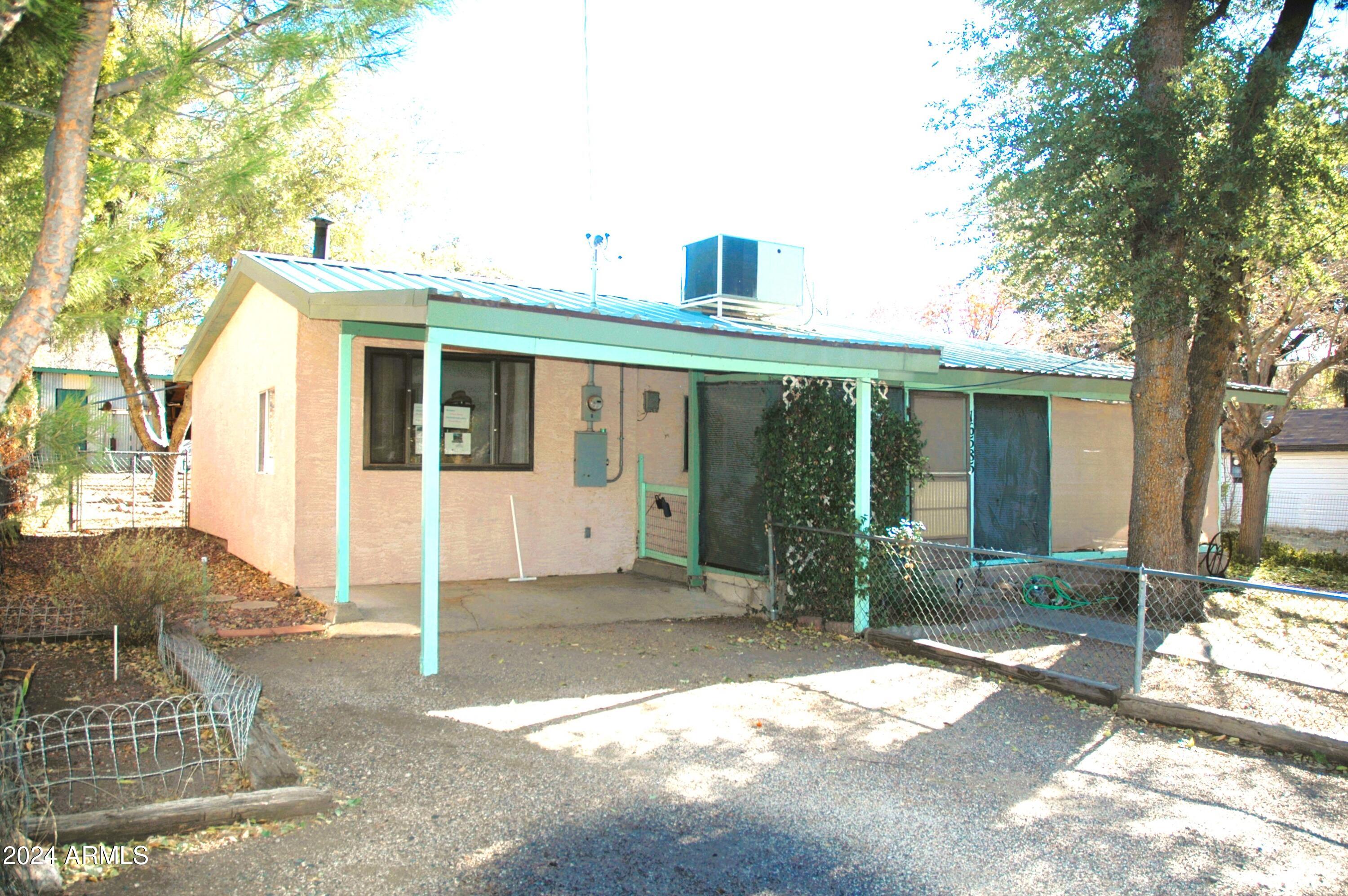 Get out of the heat for Summers, HERE IS A RANCH STYLE HOME/Cabin 2 bed/1.75 bath in Mountain Air, Just 30 minutes North of Wickenburg! DRIVE UP & ENJOY the COOL! LARGE SHADE TREES. Fruit Trees, BLACKBERRY VINES. UPGRADES THROUGHOUT THE HOME. 2 bed/1.75 bath/office space/Utility Room. ARIZONA ROOM - LAWN/GARDEN/Wood SHED- GREEN METAL ROOF- New Heatpump Air conditioner in 2025. It could be turned into a 3-bedroom, 2-bath home.