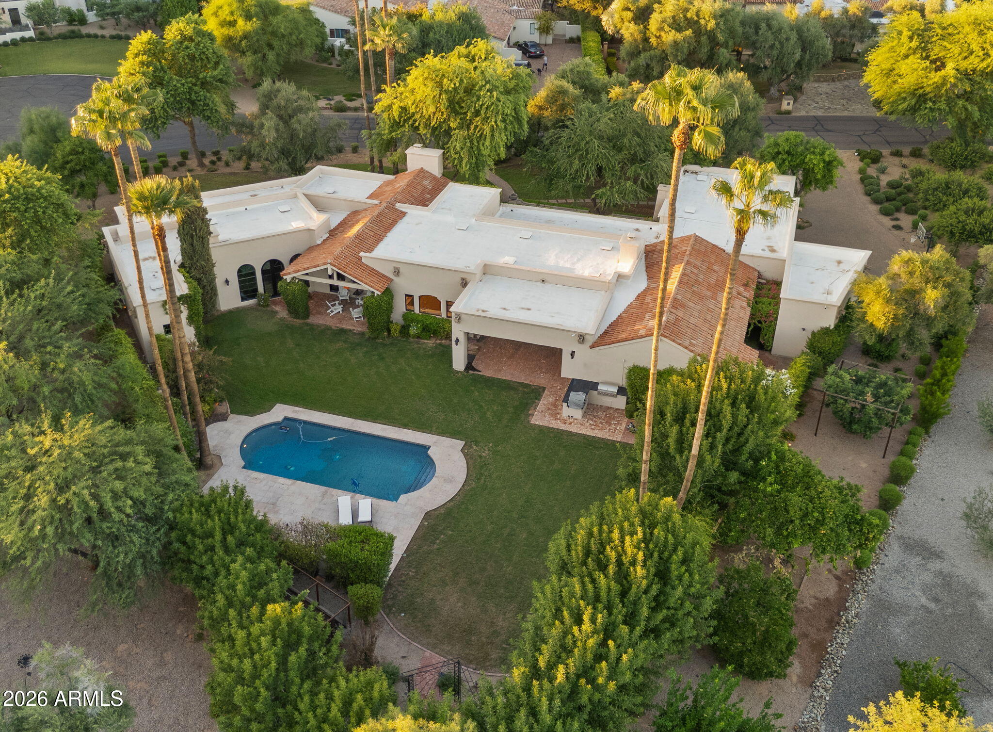 This elegant European-style estate, tucked within one of Paradise Valley's most desirable enclaves, is captivating at every turn. From the tranquil courtyard entry to the refined interiors and show-stopping backyard, every detail feels thoughtfully curated. Ideally located just minutes from iconic Camelback Mountain and the prestigious Camelback Country Club golf, this home offers the perfect blend of privacy, lifestyle, and convenience.
Set on over an acre, the resort-style grounds are truly spectacular--lush landscaping and serene outdoor spaces create a timeless atmosphere . Inside, sophisticated finishes include expansive windows and French doors, beamed ceilings, hardwood flooring, and striking stone fireplaces throughout. The home offers the warmth and ambiance of three indoor fireplaces, perfectly placed for both comfort and entertaining.
The chef's kitchen features custom cabinetry, marble countertops, double ovens, and a large center island, connecting to the spacious family room for gatherings. The expansive owner's suite is a private retreat with oversized windows and doors overlooking the backyard, plus a spa-worthy bathroom with a sauna and two grand closets.
A standout feature is the GLAM ROOM, complete with a heart-shaped Jacuzzi tuba fun and unique space perfect for that special woman, young girl, or teen who wants something truly memorable and luxurious.
Outside, the backyard is a true resort experience featuring a stunning pool with and incredible outdoor ambiance enhanced by an outdoor fireplace, creating the ideal setting for hosting or evenings under the stars. This extraordinary property must be seen in person to fully appreciate its elegance, charm, and presence.

This home is "move in ready" as furniture is available as separate bill of sale.