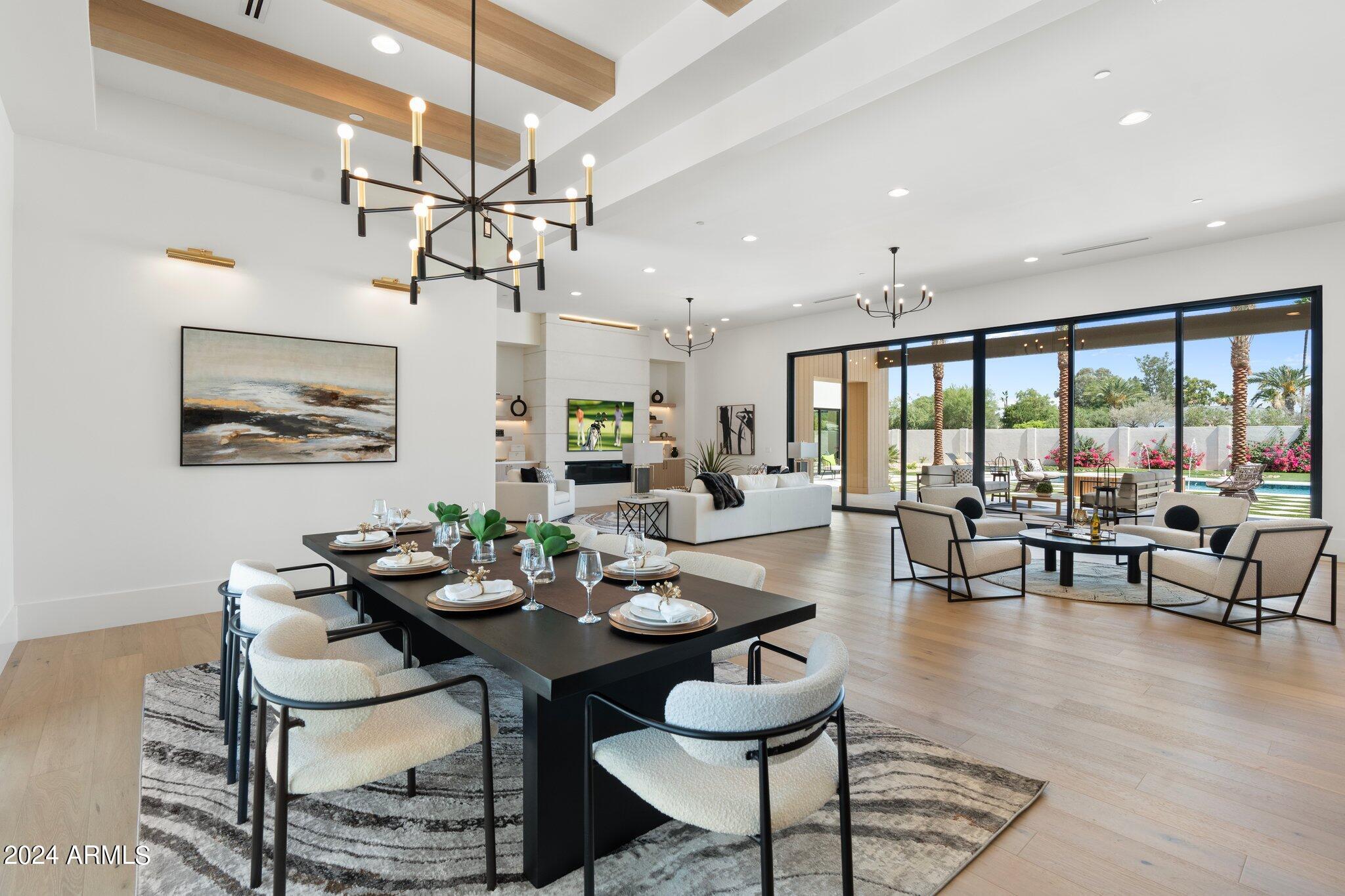 Indulge in luxury living within the prestigious Cactus Corridor with this stunning home spanning over 6191 square feet meticulously designed by Sheshadri Estate Properties.  Boasting a split floor plan, offers 5 bedrooms, 4.5 bathrooms, and a spacious secondary family room for versatile living. Upon entry, be greeted by an expansive great room seamlessly connected to the chef's kitchen, featuring top-of-the-line appliances and a massive secondary butler's kitchen and pantry discreetly tucked behind. Enjoy Arizona's indoor-outdoor lifestyle with motorized sliding glass doors opening to the sprawling backyard oasis. Outside, discover a resort-style pool, built-in BBQ area, expansive turf play area, and a spa, perfect for entertaining or relaxation. The east wing hosts a game room and 3 BRs including a guest suite with its own entrance and mini kitchenette, each with full en-suite bathrooms. The west wing features the fourth bedroom and the luxurious primary suite. Experience unparalleled luxury and sophistication in this meticulously crafted residence. Welcome home to timeless elegance.