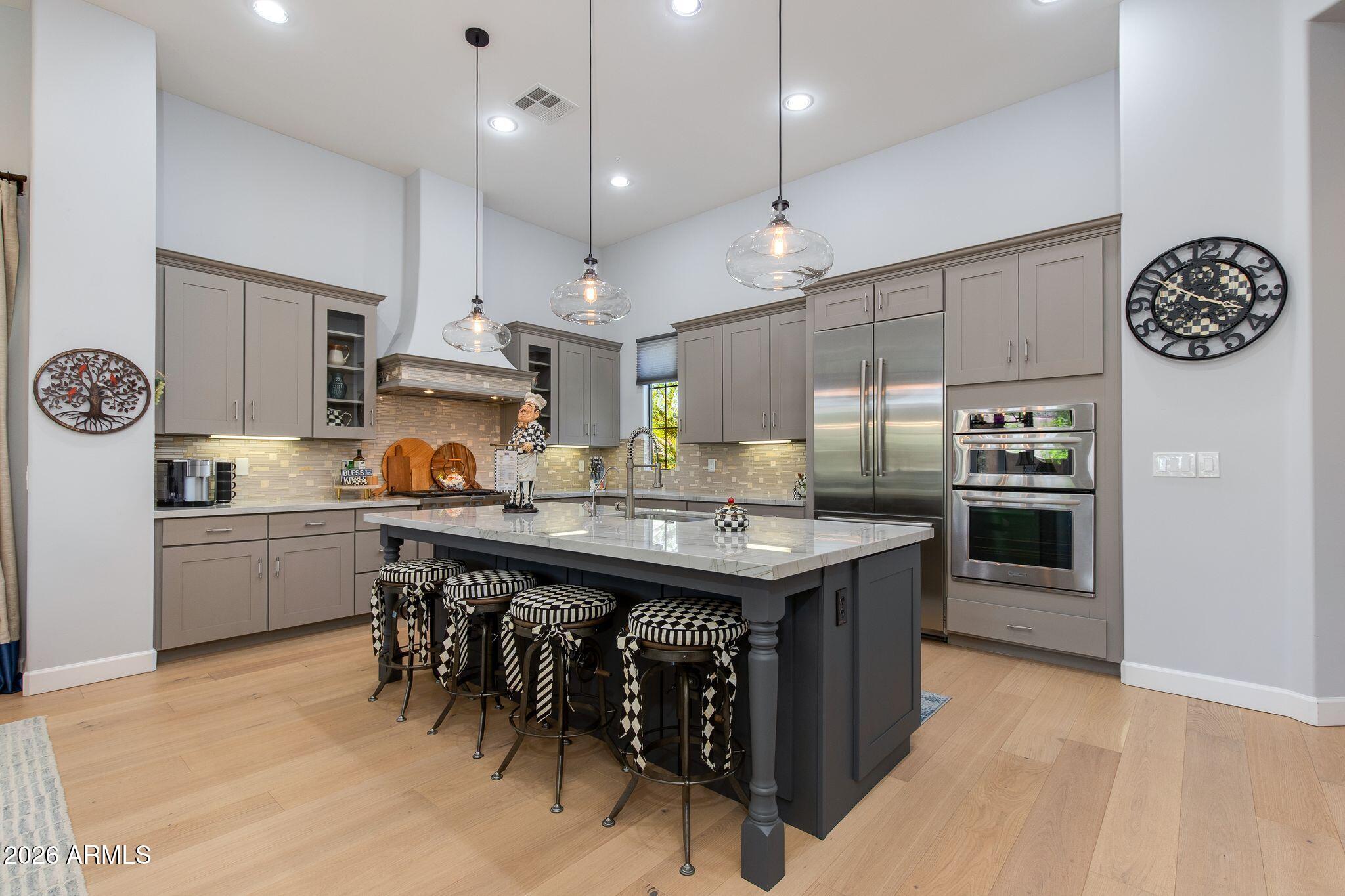 Beautifully updated former model home in a gated DC Ranch community offering 2 bedrooms plus a den and 2,645 sq ft of spacious single-level living. Features include wide-plank oak flooring, quartzite countertops, high-end appliances, updated bathrooms, new 5-ton HVAC (2024), water softener (2023), and water heater (2023). The primary suite offers a sitting area, spa-like bath, walk-in closet, and backyard access. Outdoor living includes retractable patio screens, built-in BBQ, and peaceful natural views in a private setting. Enjoy access to DC Ranch amenities including a clubhouse, fitness center, pool, tennis/pickleball courts, trails, and Market Street shops and restaurants nearby.  For those seeking a relaxing lifestyle in a beautiful home, you won't want to miss this!