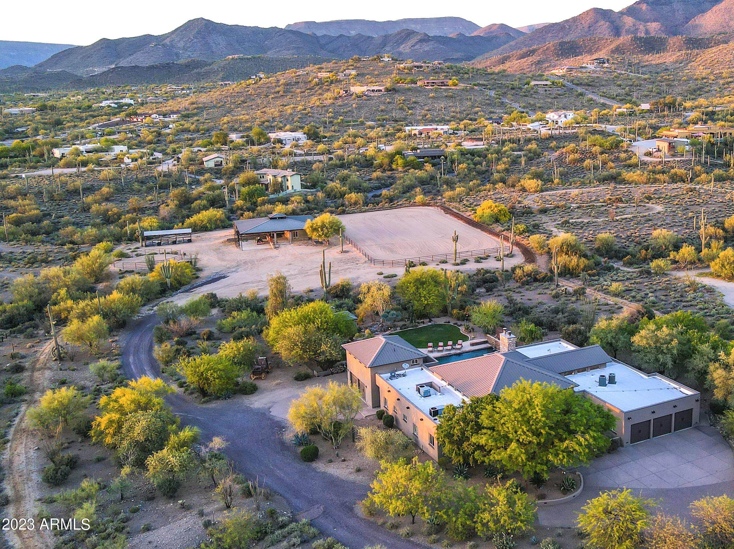 Calling all car and horse enthusiasts! At the end of this quiet, paved road is a gated estate with spectacular mountain views. Pegasus Ranch sits on 5 flat acres, with a western home, casita, theater, resort backyard and tons of open space. Bring your horses to the 100 x  200 arena, round pen, 8 stalls and tack room/barn office. Trail ride straight from the ranch to Tonto National Forest. Bring your cars, toys and hobbies too because there is ample space for a 6000+ sq. ft. car collector's garage. The main house living area has a 17 ft ceiling with a branding iron chandelier. The kitchen and bar are perfectly situated for entertaining, while the office is located for privacy. The owner's suite has views,  an extra-large closet and an exercise room off the spacious bath.  Easy to Show. Bedrooms 2 and 3 with ensuite baths, are in a separate wing. Step into the resort backyard to access the 2nd 1/2 bath and exquisite theater room, with a casita overhead. The fenced backyard offers a pool with inset spa, outdoor kitchen, and a ramada with a Jacuzzi, fireplace, and serene water feature. From the front gate to the back barn, including the exquisite living spaces, the details, workmanship and finishes are supreme.

4487 sq. ft. main home
616 sq. ft. casita
616 sq. ft. home theater
816 sq. ft. garage
436 sq. ft. barn office and feed/tack room
3844 sq. ft. open air pipe barn
FEATURES LIST 

Kitchen
"	Granite counters
"	Knotty pine cabinetry
"	Walk-in pantry with baker's racks
"	Dual dishwashers
"	6-burner Viking range with grill and double oven
"	Viking hood
"	Viking refrigerator
"	Divided stainless sink with Reverse Osmosis
"	Island with prep sink with seating 
"	Glass pendant lighting
"	Multiple entry points

Breakfast room
"	Seats 4 comfortably
"	Iron and rawhide Native American chandelier

Living / Dining room
"	Soaring 17 ft. wood plank vaulted ceiling
"	Manganese "chocolate" Saltillo floor
"	Custom branding iron chandelier
"	Kitchen pass-through
"	Stacked stone gas fireplace with remote control
"	Vutec Artscreen motorized television cover
"	Access to patio
"	Pet door

Bar
"	Seating for six
"	Beverage refrigerator
"	Ice maker
"	Sink
"	Rawhide and iron pendant lighting
"	Granite counters

Office
"	Reclaimed barnwood floors
"	Built-in cabinetry
"	Cowhide valances
"	TV with Dish, Apple 

Primary Suite
"	Stacked stone gas fireplace with remote control
"	Vutec Artscreen motorized television cover
"	Door to private patio and pool/spa
"	Carpet
"	Closet
o	Double entry walk-in closet
o	Island with storage
o	Covered glass and wood cabinet doors
"	Primary bathroom
o	17 ft. ceiling
o	Divided dual sinks
o	Vanity
o	Travertine floor and counter
o	Toilet room with laundry chute
o	Jetted tub
o	Shower with rain head, handheld, stationary and body sprays
Exercise room
"	Off primary bathroom
"	TV mount
"	Travertine floor
"	Storage shelving
"	Exit to side yard

Guest bedroom 1 
"	En-suite bath
"	Split from primary
"	Walk-in closet
"	Carpet
"	Door to pool & spa

Guest bedroom 2 
"	En-suite full bath
"	Split from primary
"	Walk-in closet
"	Carpet

Powder room in main house
"	Chiseled granite bowl sink
"	Slate counter

Storage room
"	13 ft. by 14 ft.
"	Built-in cabinetry
"	Garage and interior access


Laundry Room
"	2021 Samsung Multi-steam Smart-care washer and dryer
"	Storage cabinetry 
"	Laundry chute from primary bedroom
"	Sink
"	Ironing board

Theater
"	Tiered seating
"	JVC-D-ILA theater system 
"	Black Diamond 10 ft. by 4.5 ft. projector screen
"	Multi-aspect lighting
"	Can easily be converted to 2-car garage

Garage
"	3-car garage
"	88 in. high garage doors
"	104 in. wide garage doors
"	9' high garage ceiling
"	Epoxy floors
"	Electric opener
"	Natural light
"	Theater convertible to added 2 car garage

Casita
"	21 ft. by 26 ft. (?? Measurement not consistent with previous MLS)
"	10 ft. by 7 ft. view deck 
"	Tiled bath


Outdoor Living
"	Patio
o	Covered and uncovered with dining and bar area
o	Denon Heos wireless audio
"	Ramada
o	Woodburning fireplace
o	Above ground Jacuzzi tub
o	Fan/light with remote control
"	Kitchen 
o	Built-in Viking barbeque
o	Sink
o	Shaded
"	Powder room
o	Theater and pool access
"	Pool
o	Integrated Spa
o	Stacked natural stone and copper scuppers
o	iAqualink pool remote app control 
o	Heated
o	In floor pop-up cleaners
"	Pond with waterfall
"	Landscape lighting
"	Grass and stone
"	Firewise prevention landscaping

Horse facility
"	3844 s.f. open air pipe barn with industrial fan
"	47 ft. by 23 ft. covered concrete pad within
"	15 ft. by 30 ft. barn office and feed/tack with half bath within 
"	30 AMP and 50 AMP RV outlets
"	Riding arena with water wheel 
"	Five stalls in pipe barn with turnouts
"	Three stall mare motel
"	Round pen
"	Wash rack
"	Architecturally cohesive with main home
"	Direct access to Cave Creek trail system for horseback riding, hiking, biking

Office with Feed/Tack room at Barn
"	Half bath
"	Hot water
"	Dedicated HVAC

Miscellaneous
"	Four new air conditioners 
"	Sweeping mountain & desert views
"	Paved road
"	Custom automated security gate with app based control
"	Courtyard entry with fountain
"	Interior and exterior security camera system
"	Smart home system
"	Clerestory windows
"	Metal roof
"	Solar tubes for natural light
"	Wine storage cabinetry
"	RO Systems
"	Kinetico Premier soft water system
"	Whole house Denon Heos wireless audio
"	Recirculation pump

UTILITIES & COSTS
Electric: $335/avg. mo. 
Shared Well Water: Electric average $91/avg. mo. includes barn
Propane:  500 gal. 
Pest Control: Atomic Pest Control, termite warranty, and Sonoran Pest Control
Garbage: Area
TV: Dish/Apple TV 
Internet: Mojo Broadband
Security: AAA Smart Home app based system