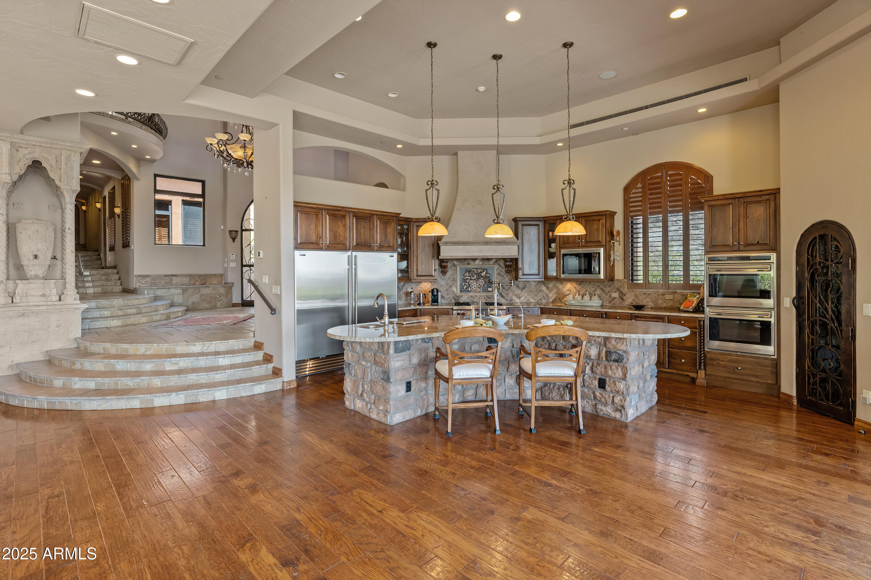 Ever want to live in the Sonoran Preserve? Endless views. Complete privacy. Located at the highest point in McDowell Mountain Ranch's prestigious, guard-gated 100 Hills. This property offers jaw-dropping, expansive views of sculpted mountain peaks, vibrant sunsets, and a sparkling city skyline after dark, all from one of the highest residential vantage points in the whole Valley. On the 1.25-acre property is a 2-bedroom guest home sitting some distance below the main home. Set behind its own private security gate, this Green Certified, steel frame residence was designed with purpose, precision, and timeless elegance. A grand entrance leads you into the spacious great room with fireplace, bar, formal dining room, and great room with an open kitchen concept Soaring ceilings and oversized windows showcase the picture-perfect views of the preserve and valley below. Chef's kitchen features Sub-zero and Wolf appliances, granite countertops and walk-in pantry. The main home has 4 ensuite bedrooms and 4.5 bathrooms across 4,388 sq ft, with one ensuite accessible from the front pathway, useful for a private home office or mother- in-law suite. The detached 1,200 sf. guest casita with separate parking has 2 bedrooms, 2 bathrooms, full kitchen, dining area, living room with fireplace, and full laundry - ideal for visitors, long-term guests, or multigenerational living. Outdoor living is a highlight, with a heated saltwater pool and spa, built-in Viking BBQ with seating around, firepit, multiple patios for relaxing or entertaining, and a backdrop that stuns from sunrise to nightfall. Additional features include Cantera stone fireplaces, travertine and wood floors throughout, power shades, central vac., outdoor shower, a 3.5 car garage, Control4 smart home system, and CCTV video surveillance. This ultra-private lot offers a secluded feel while still being part of the vibrant and welcoming McDowell Mountain Ranch community with access to resort-style amenities including six pickleball courts, tennis, an Olympic-sized pool and spa, a variety of hobby clubs and community-wide special events, nearby golf, scenic hiking and biking trails, and much more. This home sits as high as properties in Silverleaf Horseshoe Canyon or any other home in the Valley but offers greater value! Come for a sunset showing and experience the magic for yourself. This is desert living at its finest.