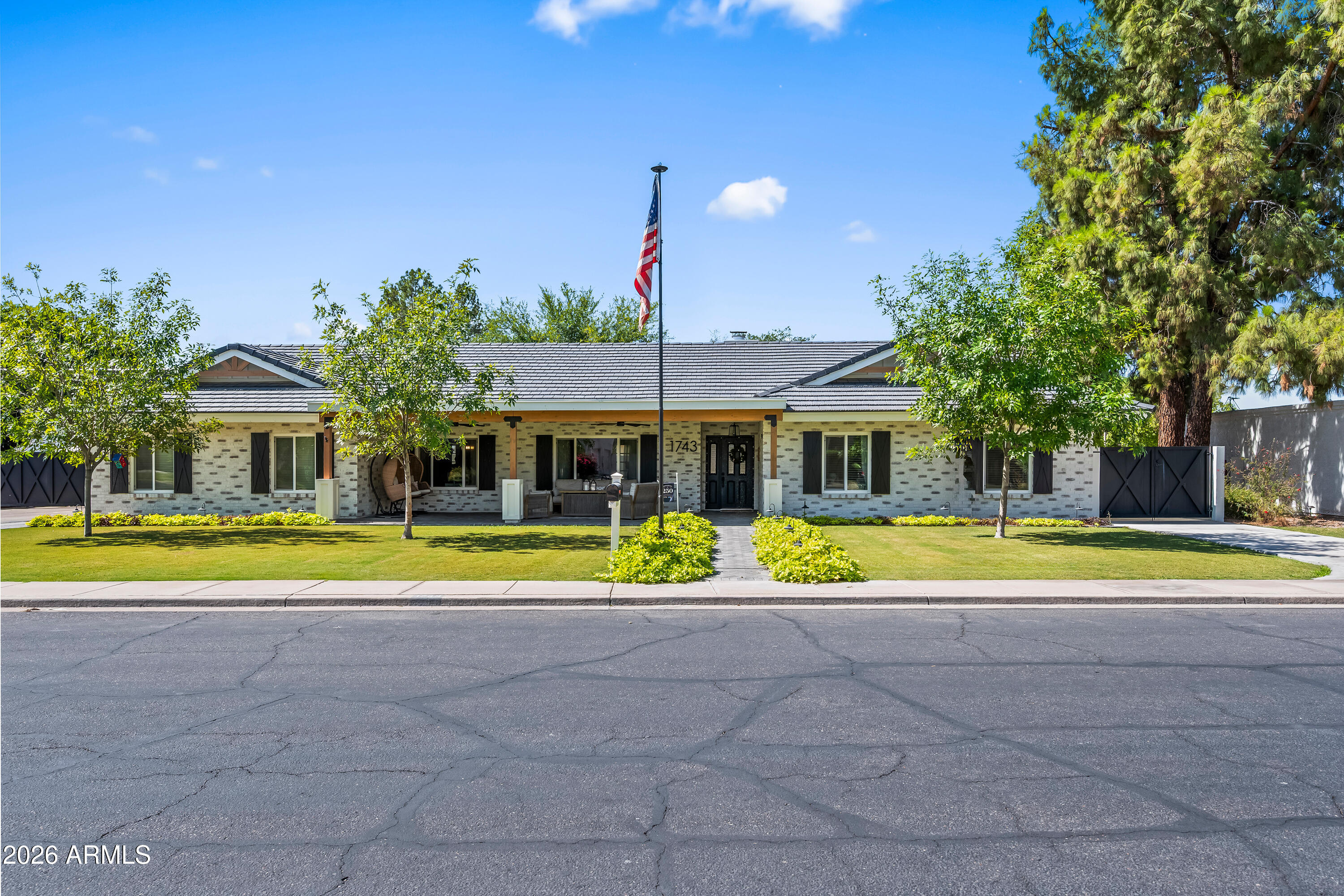 Rare opportunity on one of Mesa's most charming custom-home-lined streets. Situated on an oversized 1/3-acre lot, this beautiful brick home blends timeless character with major modern upgrades, exceptional outdoor living, and room for all the toys.  The curb appeal is outstanding with a freshly updated exterior featuring modern stucco finishes, German smear brick detail, new exterior paint, custom-beam front patio, herringbone pavers, all-new landscaping and trees, and an extra-long driveway leading to a large 2-car garage.  The backyard is built for Arizona living. The pool was refinished in 2022 with a pebble sheen finish and features a large Baja step, in-pool bar table, upgraded main pump, and a new cleaner pump. The extended back patio with custom beams creates the perfect shade space for entertaining, relaxing, and enjoying the oversized yard.  A major bonus is the extra-wide custom RV gate, offering excellent access to the backyard. The oversized shaded RV carport is 23' Wide x 56' Deep x 15' tall, and allows for side-by-side parking with two lanes of covered storage, making it ideal for multiple trailers, boats, RVs, and toys while providing protection from the Arizona sun.  Additional upgrades include dual-pane windows installed in 2023, wood-look tile flooring, interior paint, and stainless steel appliances. Located in an excellent Mesa neighborhood with near desirable schools, this home offers a quiet residential setting, a large lot, beautiful upgrades, and a lifestyle that is hard to find.  NO HOA!  This is a rare Mesa property with space, character, curb appeal, and major improvements already completed.