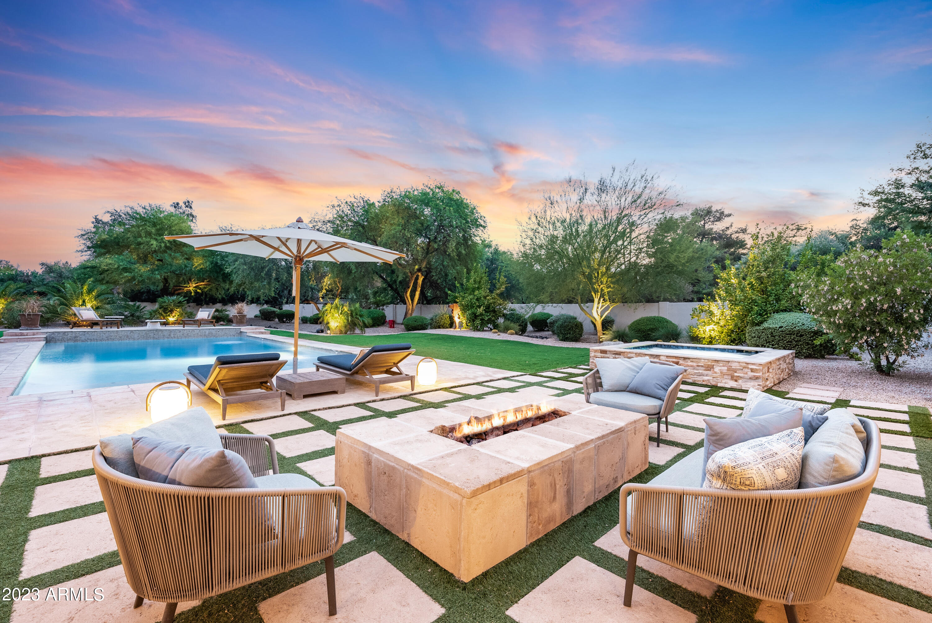 This pristine residence in the heart of Paradise Valley effortlessly combines luxury, comfort, and privacy. Situated on just over an acre, this home embodies elegance and sophistication in every corner. The spacious living room features floor-to-ceiling windows, allowing breathtaking views of the resort style backyard with a gorgeous pool, spa and expansive lawns. The gourmet kitchen boasts top-of-the-line appliances, ample counter space, and an island for casual dining. The master suite is a haven of tranquility, offering a private retreat at the end of a long day. Parking features include a 4-car garage, circular drive, RV gate and custom pavers! Close to premier shopping, dining, hiking, and some of the best golf in the country. Experience the ultimate Paradise Valley lifestyle!
