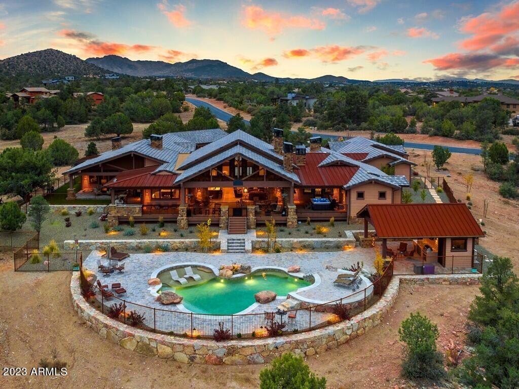 Luxury Ranch Compound with unobstructed views featuring 4 bed plus den, 5 full bath  & 1 half bath, 7 car garage (3,229 sq.ft) , 5,555 livable sq.ft, privately gated on 3.95 acres, attached guest quarters w/ exterior entrance, private pool w/cabana & restroom, Wet bar,  20 ft indoor-outdoor panoramic moving glass wall door, hot tub off master, BBQ area w/ seating, Dog run w/ artificial turf, 3 stone fireplaces, high ceilings, , Large guest bedrooms, Master bath has his & her closets, vanities, bath tub, Large walk-in shower with entrance on both sides, Wood beams, granite counters, alder wood through-out,  expansive covered patio, plank tile flooring, wood boxed beam ceilings in dining and office, & much more.