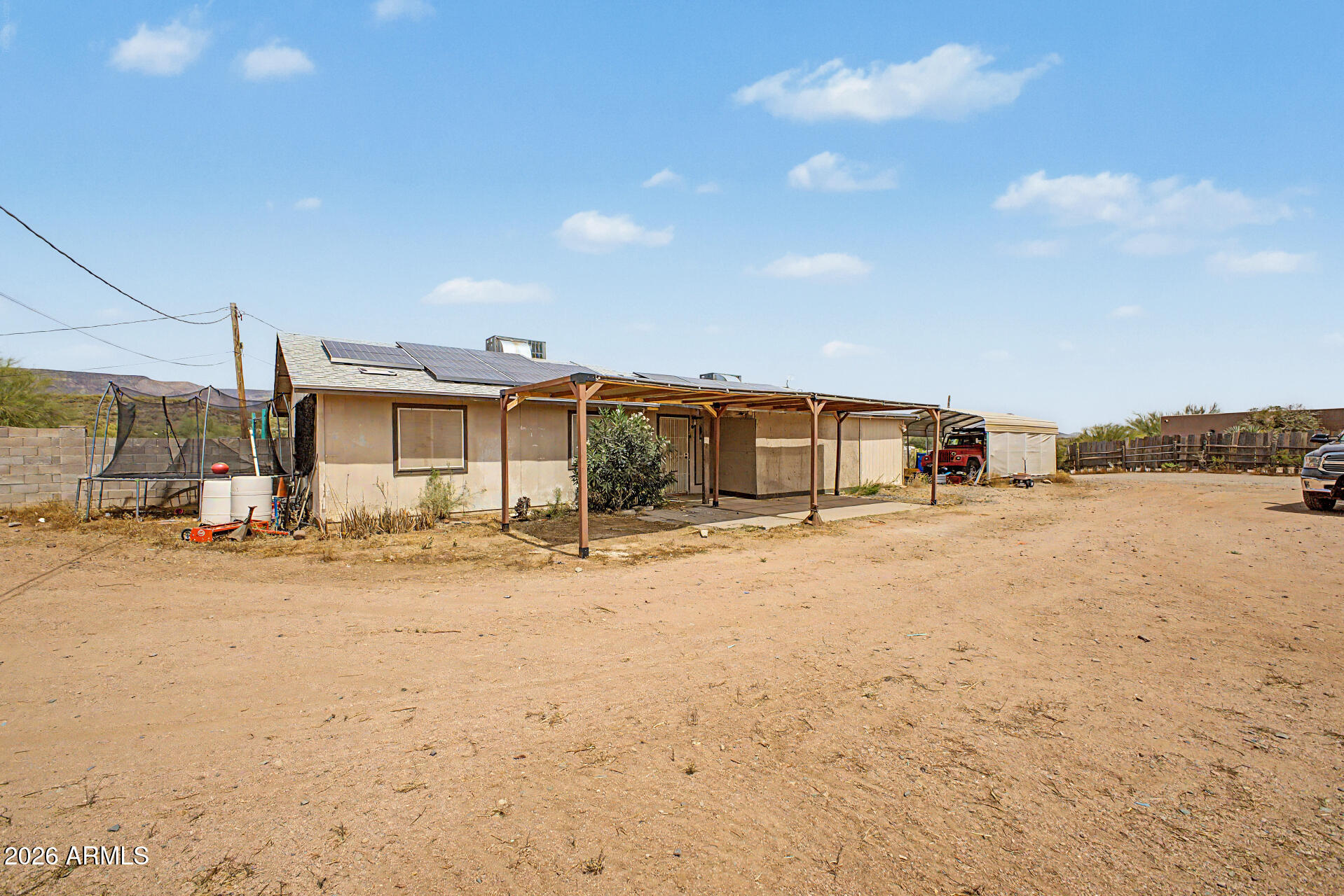 Looking for space for horses, RVs, or recreational toys? This property offers the opportunity you've been searching for. Situated on 1.2 acres, this 3-bedroom, 2-bathroom home is full of potential and awaits your finishing touches. Relax on the back porch while enjoying the peaceful desert landscape and mountain views in the distance.

Inside, you'll find an inviting kitchen featuring a spacious pantry and dedicated laundry area. The home also includes an office space along with an additional storage room, offering flexibility for work, hobbies, or organization.

Recent features and updates include a new roof installed in 2020, a whole-house water filtration system with sediment and charcoal filtration, and solar panels to help reduce energy costs and offset rising APS bills.