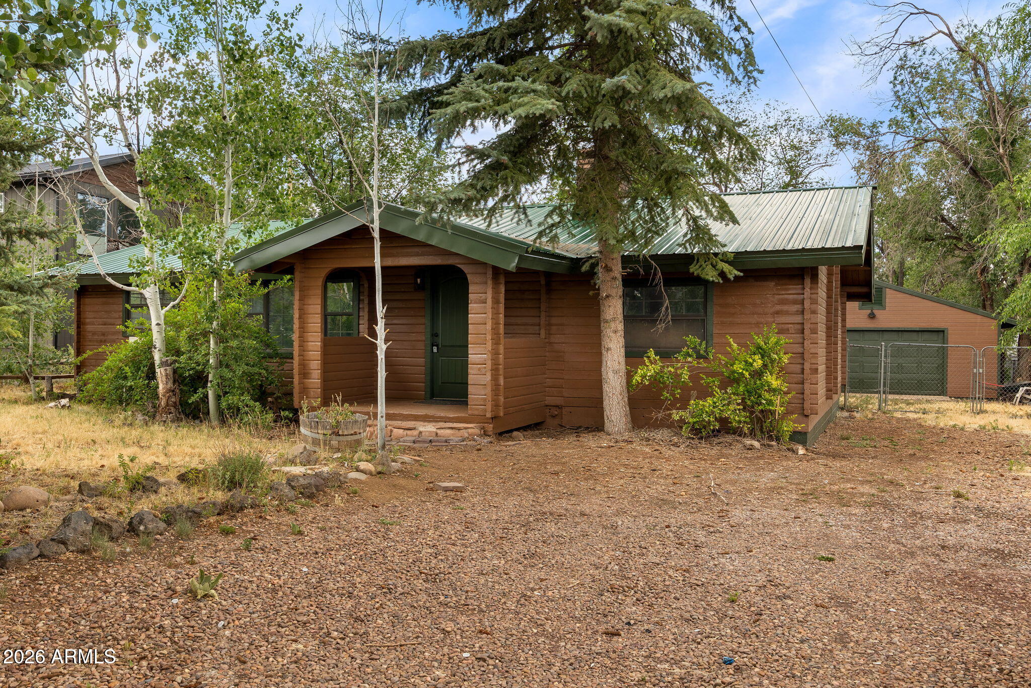 Beautifully updated 3-bedroom, 2-bath mountain cabin in Lakeside. This home features vaulted wood ceilings, an open-concept floor plan, and a striking floor-to-ceiling brick fireplace with wood stove insert. Updates include new flooring throughout, a remodeled kitchen with updated cabinetry, countertops, and stainless steel appliances, as well as new bathroom vanities and fixtures. The spacious living area offers a warm cabin feel. Enjoy covered rear deck perfect for relaxing and entertaining in the cool mountain air. Detached 2-car garage provides ample storage for vehicles, toys, or workshop space. Conveniently located near lakes, restaurants, and shopping. Whether you're seeking a full-time residence, vacation getaway, or investment property, this move in ready cabin is for you!
