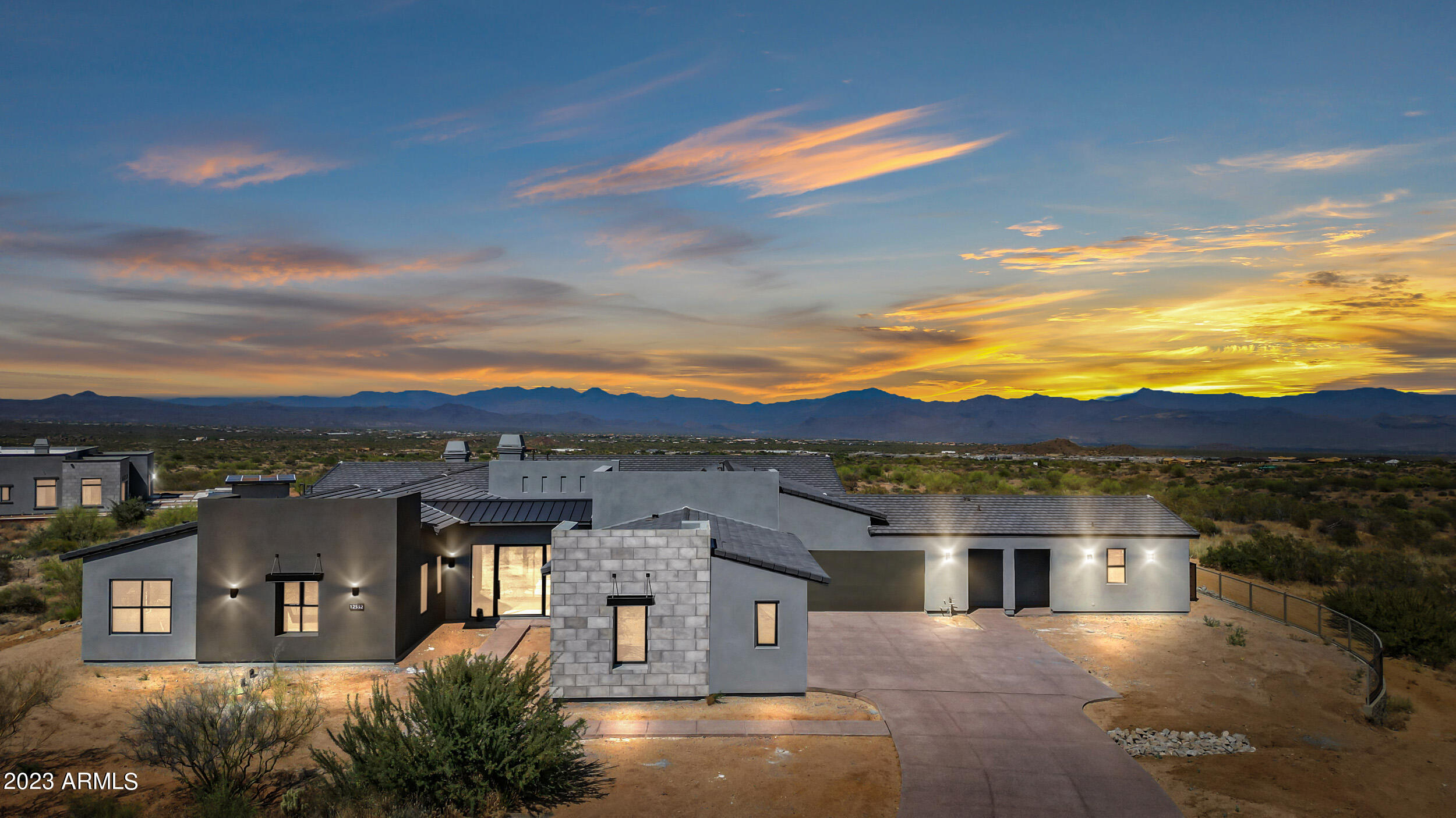 Enjoy breathtaking panoramic mountain views in this stunning, brand new construction by Toll Brothers. Situated on a premium lot tucked into a private cul-de-sac and elevated on 2+ acres overlooking the Four Peaks, this exquisite footprint offers 4 main house bedrooms each with ensuite bathrooms, plus a den / office, an oversized great room, and a separate casita with private entrance. As part of the Sereno Canyon Estate luxury community and nestled into the shadow of Tom's Thumb, this home is surrounded by unmatched views and floor to ceiling visibility. The vast great room, primary bedroom, den, and kitchen are adorned with 9' sliding stackable doors that seamlessly blend indoor & outdoor living. The home's stunning footprint provides a serene interior courtyard, 4 (indoor + outdoor) fireplaces, built-in heaters for a wrap-around backyard covered patio, and luxurious vaulted, soffit ceilings. This one-of-a-kind property has also been upgraded with ~$1M of enhancements, including a custom kitchen design, top-of-the-line finishes & appliances (Wolf, Sub Zero, Cove, wine fridges, wet bars), a state-of-the-art audio system throughout the interior and exterior of the home, and an insulated HVAC 5-car garage. No expense was spared and custom features abound! 

Part of the resort-style, staff-gated community, Sereno Canyon offers an array of amenities, including a fitness center, spa, pools, outdoor gathering areas, a café and a community fire pit. Come embrace the prestigious lifestyle NOW, without the wait. This recently completed property also offers a unique opportunity to design and customize an expansive outdoor space as well as finalize select remaining interior elements, including cabinet pulls, bathroom mirrors, and other aesthetic touches.   

This never-been-occupied home combines the prestige, tranquility, comfort, and breathtaking views of North Scottsdale with the chance to personalize your dream home and move with speed. Spacious bedrooms, extensive garage space, a fully-equipped casita, breathtaking views, and high-end upgrades are all ready now -- no multi-year wait.