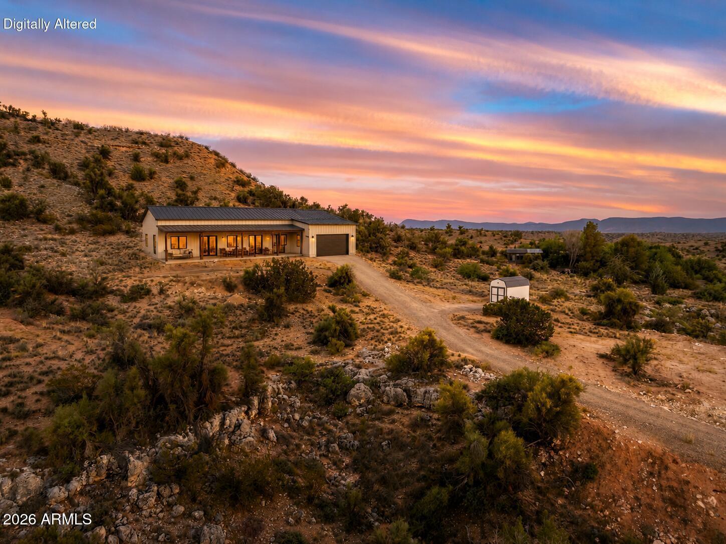 Stunning panoramic views and endless possibilities await on this premier 2.27-acre elevated parcel--the ultimate canvas to build your dream home. This land overlooks the Verde Valley, Mingus Mountain Range and Sedona Red Rocks.  No HOA, this rare property features a winding driveway that leads to two distinct building envelopes, offering the perfect layout for a main residence plus a guest house, detached workshop, barn, pool, the possibilities are endless. Floor plan concepts are available. Whether you envision a custom luxury estate, a horse property, a wine-country retreat, or simply a private sanctuary to call your own, it is the ultimate destination for anyone who wants to feel a world away but close to it all. Enjoy complete rural peace and seclusion while living just minutes away from world-class hiking, fishing, kayaking, and local wineries. This prime location offers the perfect balance of privacy and convenience--situated only 15 minutes from the every day necessities and amenities of Cottonwood, 20 minutes from Sedona, and less than two hours from the Phoenix Sky Harbor International Airport. Floor plan concepts and a site plan are available to help you visualize the endless possibilities for this incredible property.