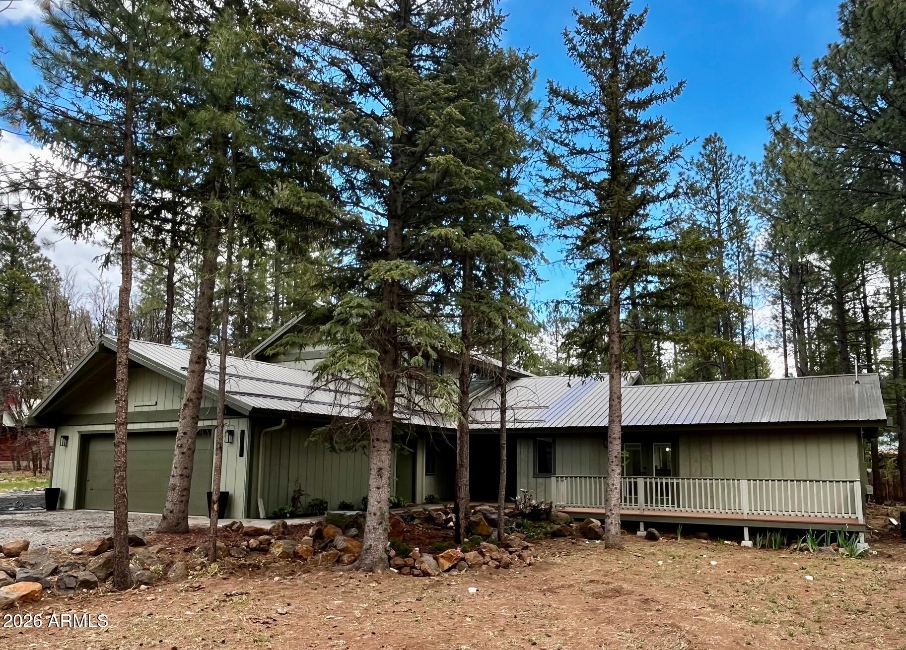 This beautiful home offers refined mountain living in the very desirable Pinetop Lakes community of Pinetop Country Club. Set on a half-acre horse property, this completely remodeled residence offers space and comfort in a serene, forest setting. 

This open floorplan home has 5 bedrooms (Master is downstairs) and 3 fantastically appointed baths. The huge entertainer's kitchen boasts premium appliances, gas-stove, custom cabinets & expansive storage, including a huge walk-in pantry.  The entrance opens to the great room with soaring, tongue and groove ceilings and a striking brick fireplace. Front and rear exterior decks invite you to spend time outside enjoying the tall pines and cool weather. With its rustic charm, this home captures the essence of modern mountain living. Sold furnishe