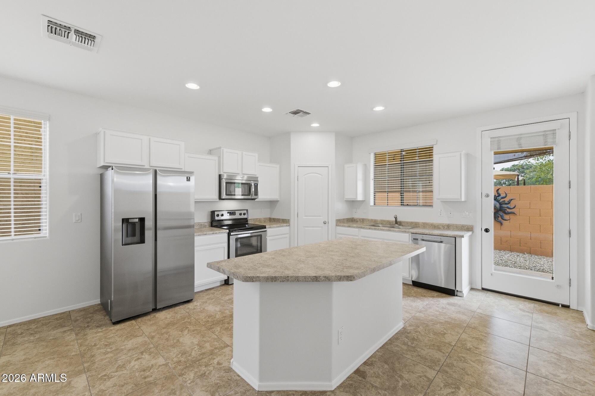 This 1,892 sq ft single-family home offers 3 bedrooms, 3 bathrooms, and a functional layout with plenty of space. Recent updates include new interior paint, new carpet, and new rock in the backyard. The main level features tile flooring, an open living area, and a kitchen with white cabinets, stainless steel appliances, a large island, and good counter space. The backyard is low maintenance with a covered patio, making it easy to enjoy the outdoors. Located in a community with a pool and park, this home offers everyday convenience and useful amenities.