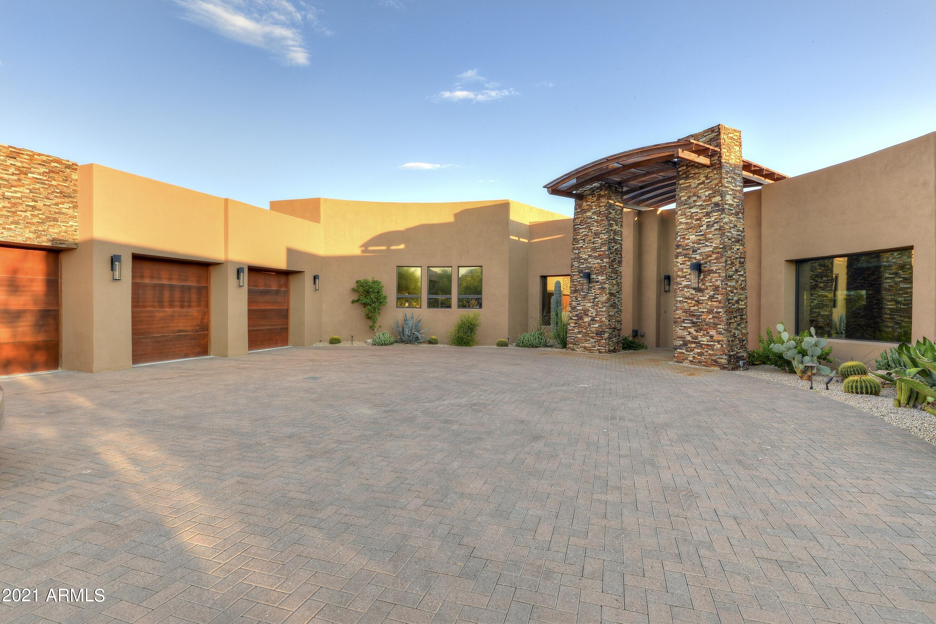 A beautiful soft contemporary home in the village of Sunrise.  Guests are welcomed by a generous motor court upon entry.  The main living area is a spacious 5300sqft, all on one level.  A downstairs flex room with bath and storage round out the interior space.  The southwest exposed outdoor living area is ideal for the entertaining lifestyle.  It features a reverse negative edge pool and spa, waterfall trays and fire pots.  An outdoor kitchen and several seating areas are situated to bask in the fabulous desert evenings. Enjoy mountain views from every direction and the year round green grass of the Renegade course. The primary bedroom has easy access to the awaiting spa and outdoor living area. All four bedrooms are ensuite, with a dedicated home office adjacent to the main living space.