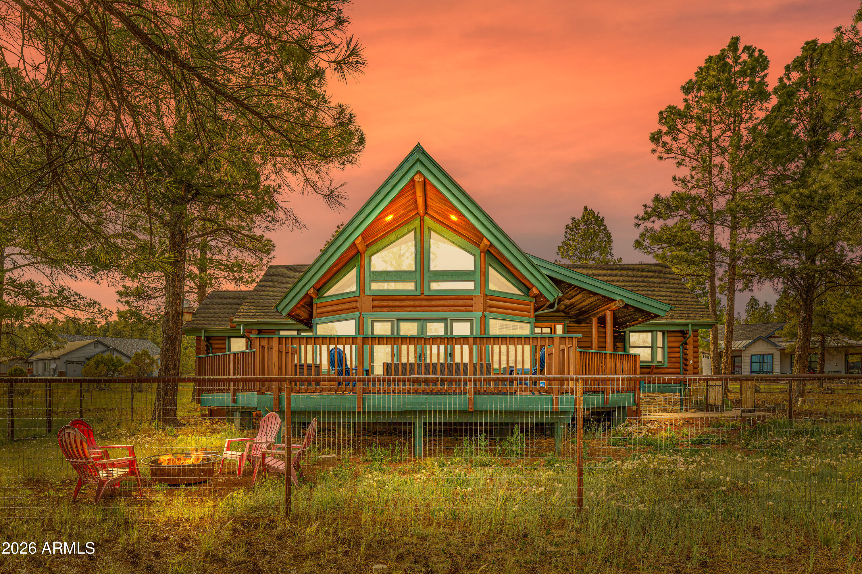 Fantastic 3 bed, 2.5 bath true log cabin on 1.1 acres in Williams! Currently a successful vacation rental, it features vaulted ceilings, hardwood floors, and a cozy wood-burning fireplace. The kitchen offers ample cabinets, counter space, and a center island. Primary suite includes dual sinks and a jetted tub. Relax on the spacious deck surrounded by mature trees. 3-car garage plus city water/propane stubbed to the road for future connection. Ideal as a full-time home, getaway, or investment property!