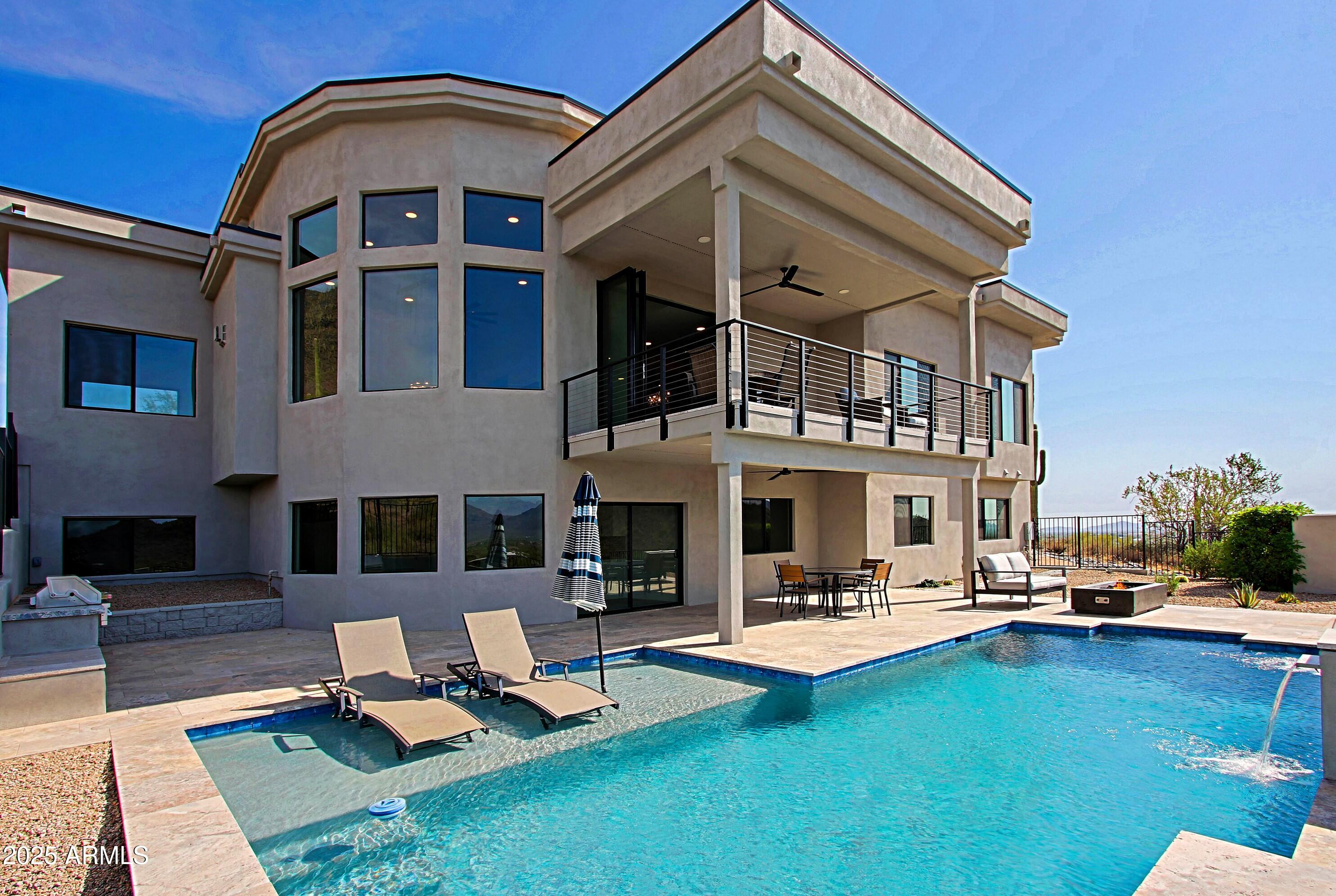 Builder's own home, View! View! View! 360Degree views of city and mountains.  A Modern /contemporary home. A must see! Kitchen with amazing island with prep sink. Water system is all electronic to purify and remove harmful chemicals. A 2nd laundry is located in the lower level for convenience. Hallways are 48 inches wide. Heavily optioned pool. Home has upgraded insulation for energy. Photos are in now. The area that is N&E of home with all of the saguaros is city owned and can't be built on as of this writing. AND NO HOA :)
NEW INFO! Seller is offering a 1-year WARRANTY on this HOME, with an accepted offer. PLUS, a 1 YEAR HOME WARRANTY to cover the OTHER ITEMS other than the Structure.