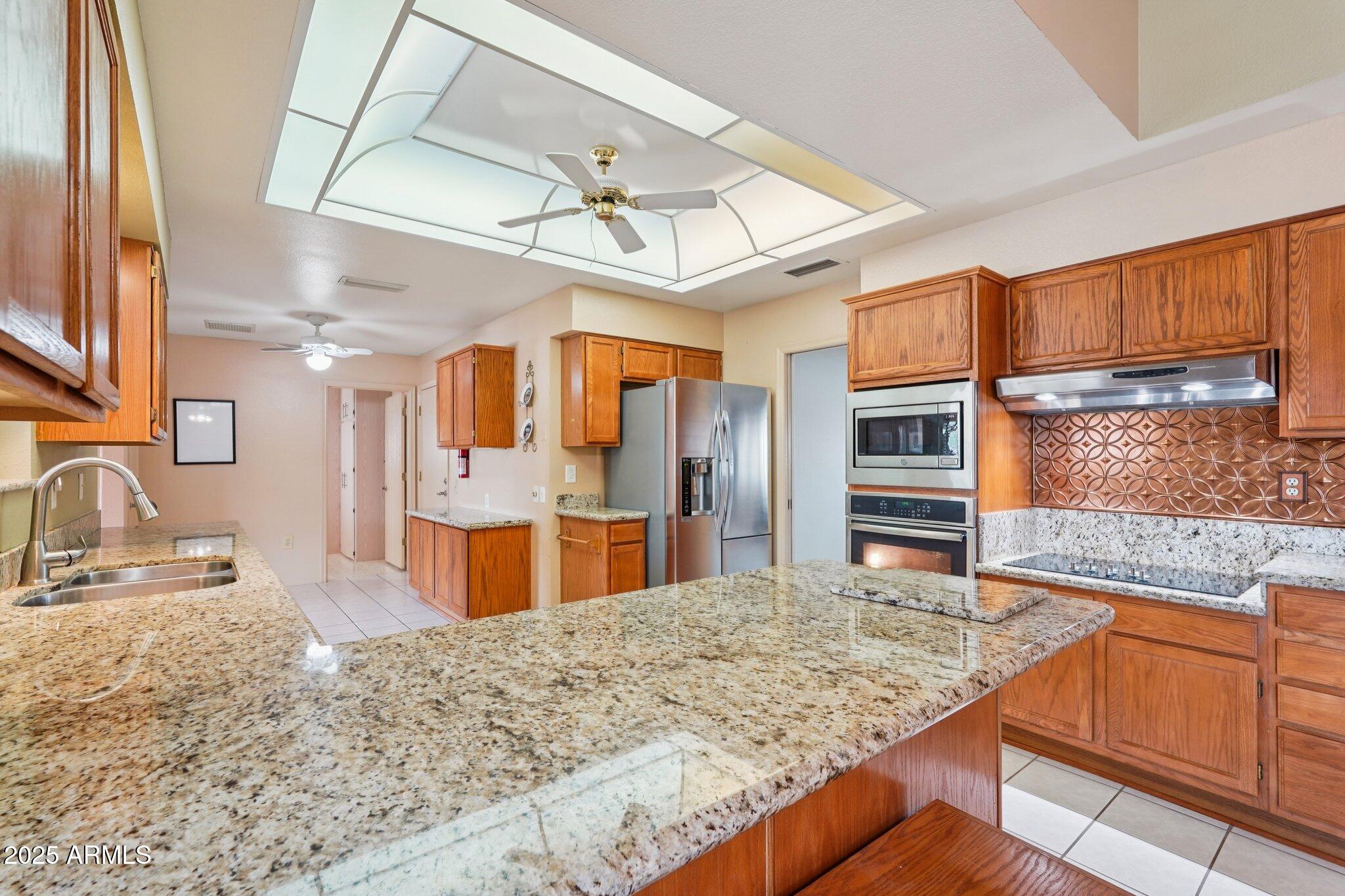 Welcome to this Updated & Expanded Hopi Model with COMPLETELY PAID OFF SOLAR!!!!!  Enter the foyer to the Great Room with vaulted ceilings.  The open concept kitchen has been updated with granite counters, stainless steel appliances, and a breakfast bar.  The extra-large Utility room can be used as a craft room or office and has a utility sink for convenience. Both bedrooms feature walk in closets.  Plantation Shutters are throughout the house, over $12,000 of windows were installed in 2015 & 2017.
This home expanded/enclosed Arizona Room, approx. 400 sf, & has its own HVAC zone. installed in 2015.  Two car garage w additional storage.  The private and completely fenced back yard features 2 mature citrus trees. This house is powered by PAID Solar which keeps Utilities low.