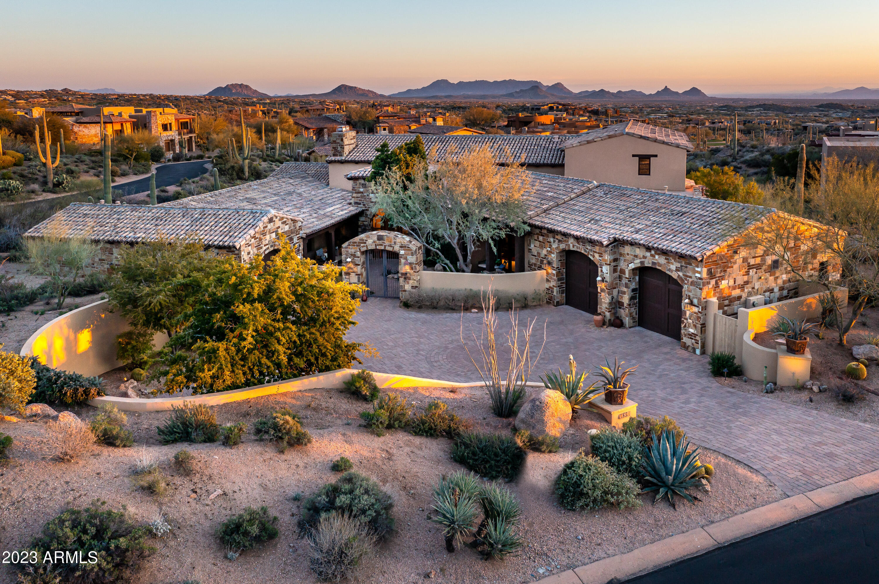 Golf Membership available with this beautifully appointed Old World home in Desert Mountain's Saguaro Forest Village.  Stunning Valley views provide year-round sunsets and city lights.A charming entry courtyard welcomes to the spacious great room with open plan and many custom features including gorgeous beams, stone fireplace and flooring , stunning dry bar, vaulted brick ceiling in kitchen, and designer lighting throughout. Resort patio boasts new spa and soothing water feature. Master bedroom is split with 2 additional ensuites on main level with large inside casita on the second level, complete with sitting area, kitchen bar and view patio. Creatively and impeccably appointed; furniture is available under separate agreement