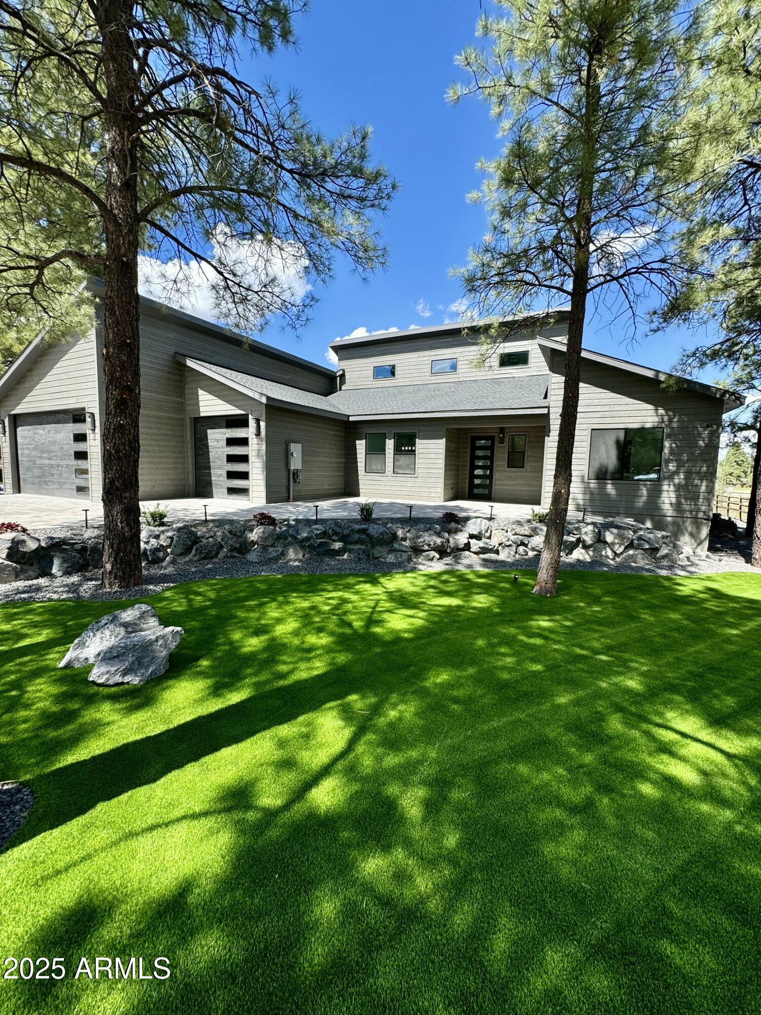 Elephant Rocks Golf Course now Open! Enjoy some golf, then come see this STUNNING NEW Custom Home. With sophisticated curb appeal, dramatic architecture & landscaping. Grand Great-Room featuring 23ft vaulted beamed ceilings, transom windows, Tiled gas fireplace (w 85'' TV inc.), spacious dining area, & 16ft sliding doors opening onto 550sqft covered trex-deck. The impressive Kitchen includes ZLINE appliances with 48''Gas-range & Dual ovens, 60'' Fridge/Freezer, Custom Cabinetry, elegant backsplash & large Quartzite waterfall island. Home fully Prewired for security, surround sound & electronics. 2 AC UNITS +AC & Heat in garage. Master bedroom has deck access, upgraded walk-in closet, ensuite w dual vanity, soaking tub, large shower w dual shower heads/controls & heated towel rack. Oversize guest rooms have California closet systems (similar to Master closet) & prewired for wall mounted TVs. Both baths 2 & 3 feature elegant tile work. 
Backyard features covered patio deck perfect for entertaining & a grand staircase leading down to the peacefully landscaped backyard with 2000 sq ft of premium Turf, accent boulders, & prewired for landscaped lights & irrigation, plus fully fenced for pets. RV gate & under deck storage make storing toys a breeze.  
The front yard also includes premium Turf, landscape lighting, irrigation to plants & trees, over 100,000 lbs of boulders per Architectural design, & oversized Belgrade pavers on driveway & entry. 
Everything about this home is carefully designed & upgraded... From the raised driveway & foundation to prevent snow pile, to the 5+ car garage for all your vehicles & toys, upgraded spray foam insulation (ceiling and walls) & ducting, upgraded plank tile flooring, & dual AC units for comfortable summers, to the Composite siding w 50yr paint guarantee, powder-coated deck railing that will never rust, & Upgraded lighting both inside & out. It also features a Steel Front Door with keyless entry, oversized garage doors, Solid core interior doors, Metal framed windows, ZLINE appliances (range, oven, microwave & dishwasher), plus under cabinet lighting in kitchen and pendant lights at island, plus upgraded single basin kitchen sink (with Insta Hot water), pop up outlets in island with wireless phone chargers, Kohler sinks at baths & water closets prewired for electrical (for heated/automated toilet plumbing). There is recessed lighting thru out, ceiling fans with remotes, side yard garage access, fully equipped laundry with new washer, gas dryer & laundry sink, tankless gas hot water heater, AC and Heat in garage, plenty of storage, lots of natural light & so much more!
Nestled in the tall pines, steps from National Forest & surrounded by Elephant Rocks Golf Course, this beautiful Mountain Retreat has well designed and thoughtful amenities & is move-in ready. All within minutes of downtown Williams with shopping, dining & entertainment. Come see the best of Modern Elegance in the Pines.