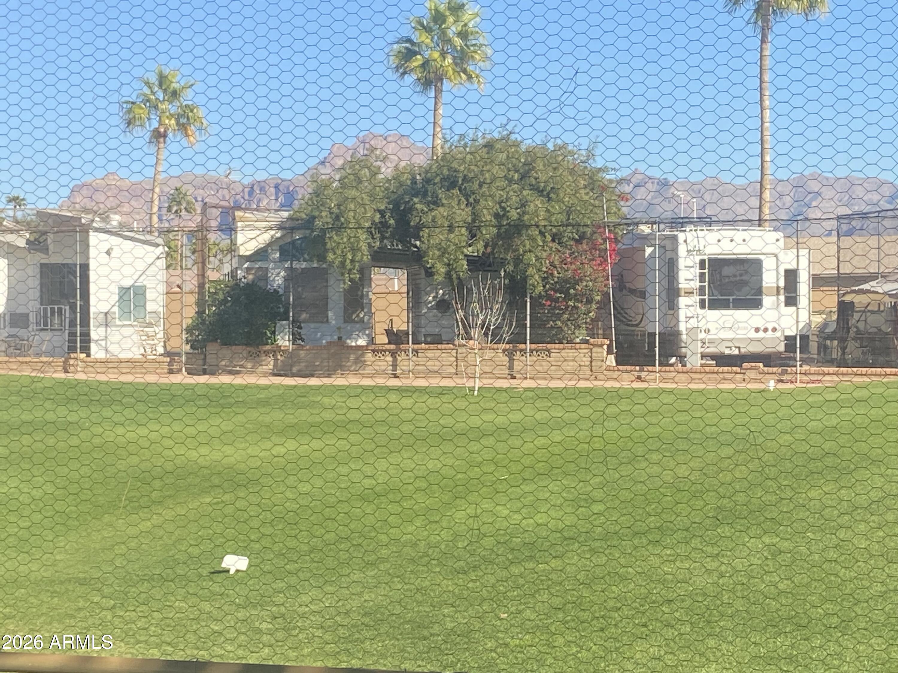 On the golf Course with east facing views of the Superstition Mtns. 55+ resort with endless amenities! On site restaurant, lap pool, therapy pool, large play pool and 2 spas PLUS exercise room, billiards, pickle ball, tennis, bocce ball and large list of clubs and entertainment.  AC/heat was new in 2019. Windows have been replaced. New solid surface flooring, Arizona Room addition, large second bathroom/laundry. Plenty of room for guests, fully furnished. Attention to detail on interior finish. Spic-n-span clean move-in ready! Plenty of time to enjoy the Arizona sunshine this season. Can be shown on short notice.