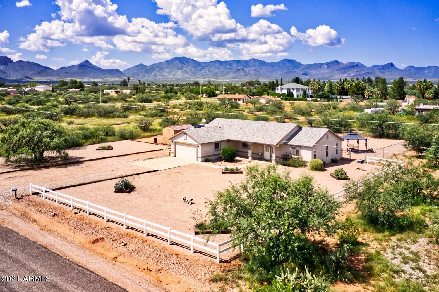 Here is your opportunity to live the country life, On paved city maintained road., Close to Fort Huachuca ,Sierra vista and 15 minutes to the  I-10.Fenced   Private 1 acre lot. Enjoy  panoramic  mountain views under your covered patio or relaxing gazebo. Front door enter  into an open  floor plan, split  3 bedroom, 2 bath. Primary has separate his and her vanity, large garden tub,
walk in closet, Pass through kitchen compete with stainless steel appliances, Pantry closet. Ex deep  2 car garage . Storage shed and R.V. parking with gate.