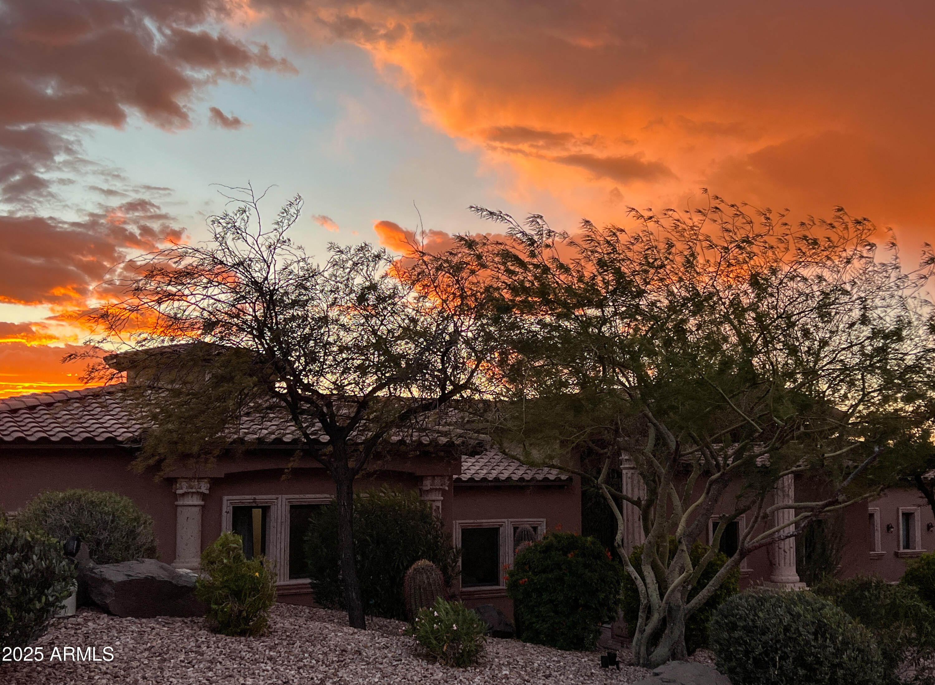 More than 180-degrees of sweeping views will inspire and awe, as you step through the front door of this finely appointed residence. From the grand entry foyer, the home opens into an elegant entertaining space with the kitchen, breakfast nook and living area. The wide terrace outside the living room beckons you to step out and savor the sunsets, which paint the nearby mountains in warm mauves, while the valley floor rolls out beneath you to the horizon. Truly an unmatched property with generous use of carved Cantera stone that enhances the architecture, both indoors and out. A newly landscaped backyard and a sparkling pool embodies desert living at its finest. Want to store vehicles or toys? This home boasts a huge garage with plenty of height for lifts - and ample slab parking outside.