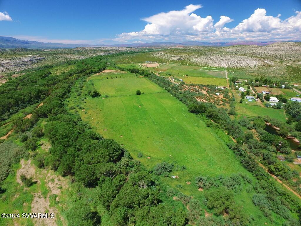 Secluded 58 ACS. Farm/Ranch - Tree filled Verde River frontage - irrigation water rights filing claims to irrigate four pastures above the Verde River. 3 wells in total for domestic and irrigation use. One 12'' well is 250 Ft. deep that was previously tested at 90 GPM with a water filing claim for up to 25 acs.  Well irrigated pastures above ditch need new pipping to deliver the well water to those fields. A 40X40 hay barn & separate shop Bldg. Scenic pond.  Fenced and cross fenced. 3 Septic - APS power. Build your new home. here and enjoy peace and quiet. Fishing and kayaking . Only 20-30 minutes to Cottonwood or Sedona. Sellers request Buyers show proof of funds to purchase property prior to making appointment and Buyer requests Lawyers Title of Cottonwood be the escrow company in sale Close shopping at Camp Verde Bashas supermarket, Cottonwood and Sedona airports.  Buyer prospects to provide proof of funds to Seller. Then make an appointment to view property.