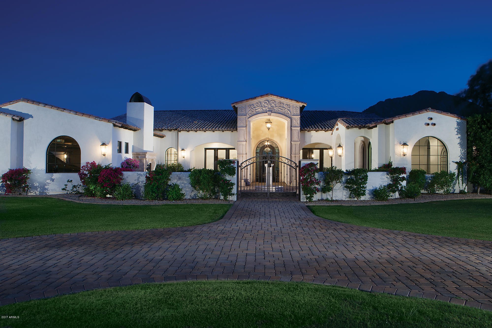 This beautiful 6,917/sf single level estate was built in 2015 and is nestled on an acre plus lot between Camelback and Mummy Mountains. Camelback mountain views from kitchen, family room, living room and pool. It features an office plus 7 bedroom and 7.5 baths including a two room guest house and a casita. The split floor plan includes living room, formal dining room, wine closet, office with the kitchen opening to a large family room and breakfast area. High end finishes abound including wood floors throughout and marble baths. The motor court is gated leading into the 4 car garage. The property is lushly landscaped and includes a circular front drive, pool, spa, pool cabana with fireplace, BBQ, front courtyard with fireplace and fountain. The motor court is gated leading into the 4 car garage. The acre plus lot is lushly landscaped and includes a pool, spa and Barbecue.
