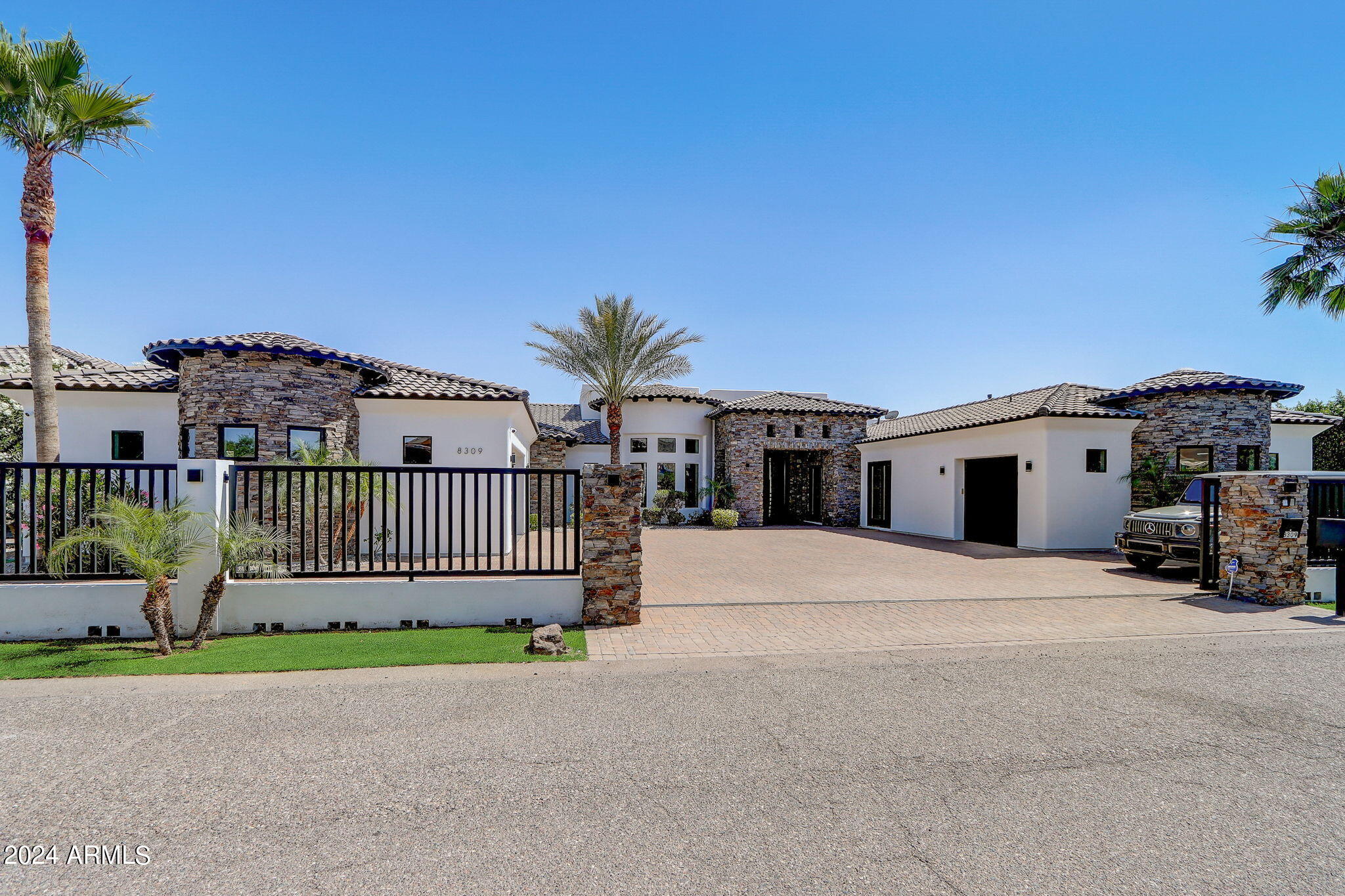 Step into a realm of luxury and practicality with this stunning custom-built residence, a perfect haven for families who cherish the outdoors and love entertaining. Built in 2015, this exquisite home is a blend of modern design and comfort, situated in the serene landscapes of North Peoria.As you drive through your private gate with custom pavers, you're welcomed by bold iron doors that open into a spacious foyer. This leads you into an expansive, open-concept living room that effortlessly extends to an outdoor entertainment area through sleek sliding glass doors. The home's 100% smart functionality is powered by Unifi 4k security system cameras, Sonos, and Genelec professional speakers, offering customizable surround sound in every space, both inside and out. ( see more remarks) Step into a realm of luxury and practicality with this stunning custom-built residence, a perfect haven for families who cherish the outdoors and love entertaining. Built in 2015, this exquisite home is a blend of modern design and comfort, situated in the serene landscapes of North Peoria.As you drive through your private gate with custom pavers, you're welcomed by bold iron doors that open into a spacious foyer. This leads you into an expansive, open-concept living room that effortlessly extends to an outdoor entertainment area through sleek sliding glass doors. The home's 100% smart functionality is powered by Unifi 4k security system cameras, Sonos, and Genelec professional speakers, offering customizable surround sound in every space, both inside and out. To the right of the grand entrance, a private attached casita awaits, perfect for guests, a nanny, or in-laws. This self-contained suite features its own kitchen, bathroom, and garage, ensuring privacy and independence for your visitors. The residence boasts a true split floor plan, with the primary bedroom located on the east side. This peaceful retreat offers separate his-and-hers walk-in closets, a luxurious rounded walk-in shower, and direct access to the patio. The built-in fireplace and rounded windows provide picturesque views of the sparkling saltwater play pool, complete with a spill-over waterfall from the hot tub and a built-in fire pit. On the west side, you'll find bedrooms two through four, each with en-suite bathrooms, walk-in closets, and sliding glass doors leading to private patios. These rooms are designed for maximum comfort and functionality, offering ample space for family or guests. An oversized flex space adjacent to these bedrooms is perfect for movie nights, a game room, or a second living room, with sliding glass doors opening to the private patio and backyard oasis. The kitchen, a chef's dream, is equipped with high-end finishes, stainless steel appliances, a six-burner gas cooktop, an oversized island with seating for eight, a beverage fridge, and a built-in Wolf coffee machine, making it the perfect spot to start your mornings. The backyard is a private, lush paradise, ideal for both entertaining and relaxation. It features an extended patio with a TV, a saltwater play pool, a spa with a spillover waterfall, and an in-ground gazebo with a dining area and built-in BBQ and kitchenette. Two expansive grass areas provide great spaces for kids to play or for hosting gatherings. The backyard landscape, redesigned by Moon Valley Nursery at a cost of $100,000, adds privacy and a resort-like feel to your home. Let's not forget the detached 60x20 ft RV garage with a 16 ft opening and two ductless mini-splits, offering ample room for storing an RV, boat, and all the recreational toys your heart desires. As a bonus, there is additional parking to the west of the building, equipped with two floodlights and 50-amp outlets inside and outside the garage. With Lake Pleasant and numerous riding, biking, and hiking trails just a few miles away, life in this home couldn't be more perfect. This residence seamlessly combines luxury and practicality, providing a comfortable and stylish living environment in North Peoria. Welcome to your Peoria Paradise!