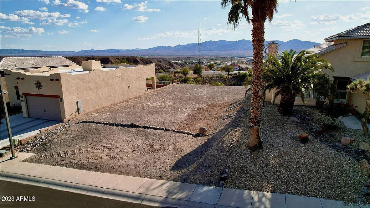 Indulge in the mesmerizing panorama of the Black Mountain Range & Colorado River from your future dream home! This forthcoming residence graces one of the last coveted view lots in El Camino Village. Featuring Dual Master Suites, 3 Bed/3 Bath, 10' Ceilings, Gourmet Kitchen & RV Garage! Expansive glass doors allow natural light to fill this home! Revel in the beauty of vibrant sunrises, enchanting sunsets, & stargazing under the night sky. Tailor every design element to your taste. Ample space for Pool/Spa. Perfectly located w/swift access to HWY 95 & the new bridge to Laughlin, NV for exceptional shopping, golf & entertainment. *Home depicted is a larger model. Plans show exact layout. City-Approved plans/permits included.